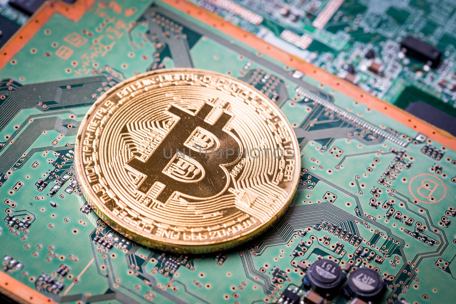 Bitcoin, the digital currency in studio on motherboard backgroun by Alicephoto