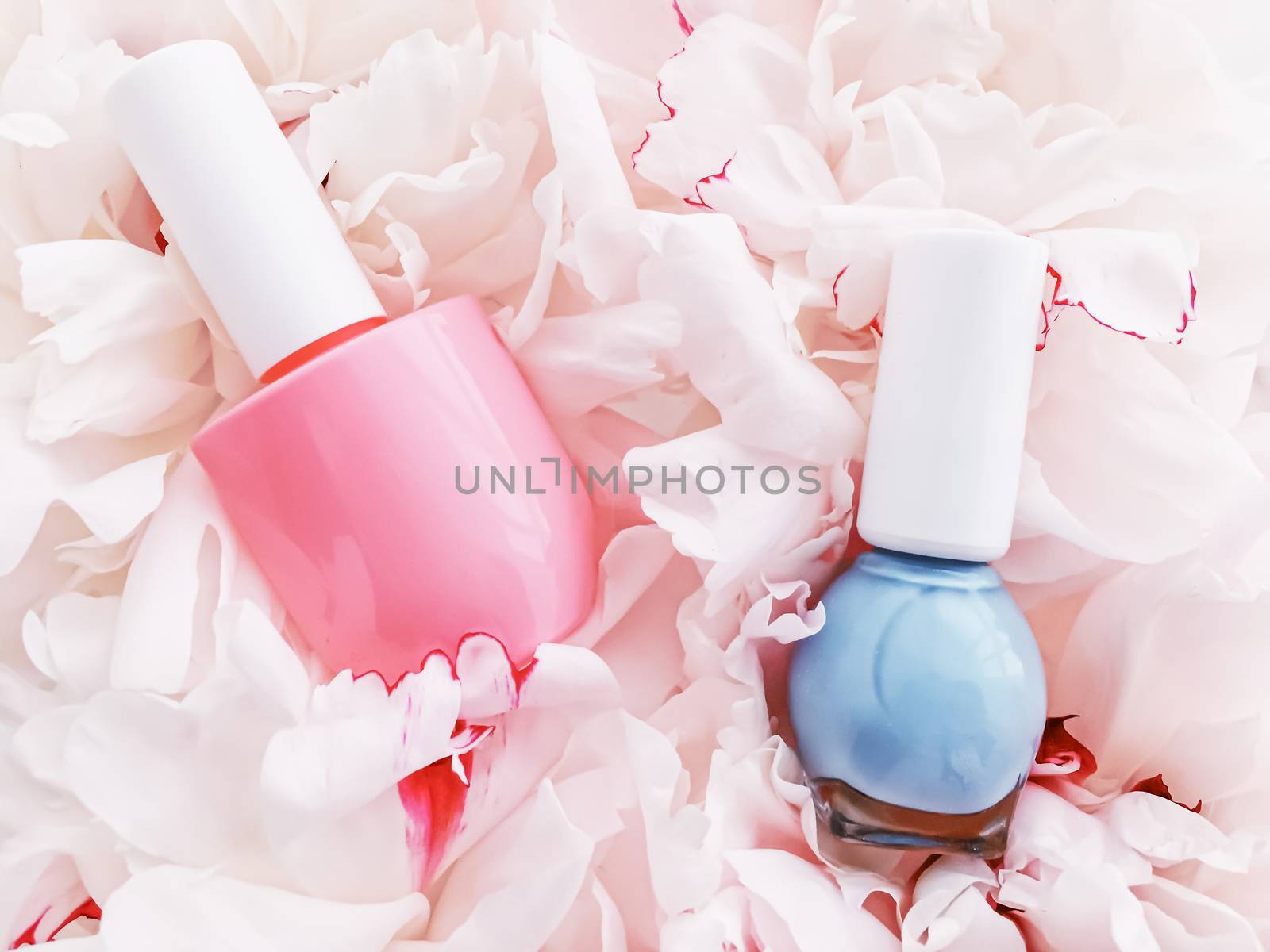 Nail polish bottles on floral background, french manicure and cosmetic branding design