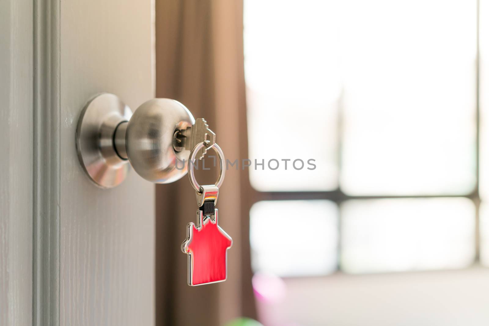 Home and housing estate concept, a key to open the door by Alicephoto