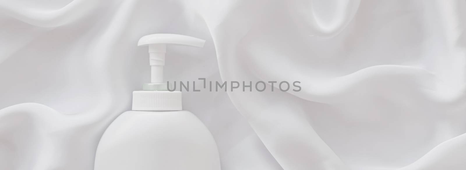 Blank label cosmetic container bottle as product mockup on white silk background, hygiene and healthcare