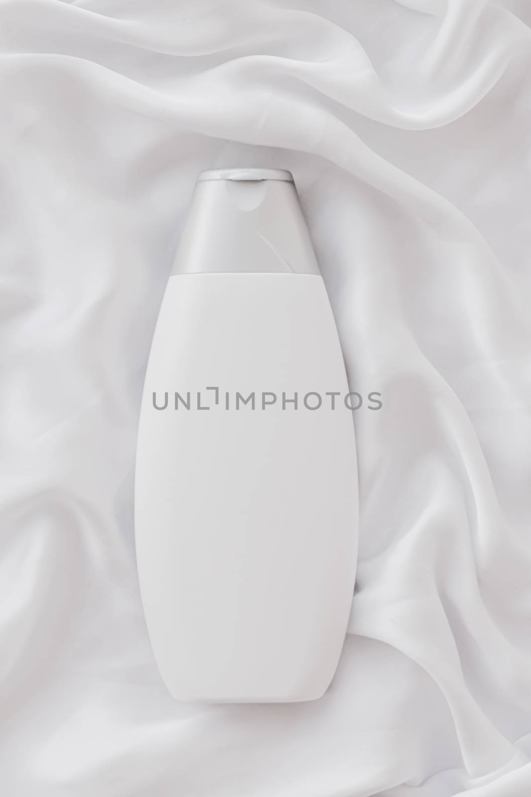 Blank label cosmetic container bottle as product mockup on white silk background, hygiene and healthcare