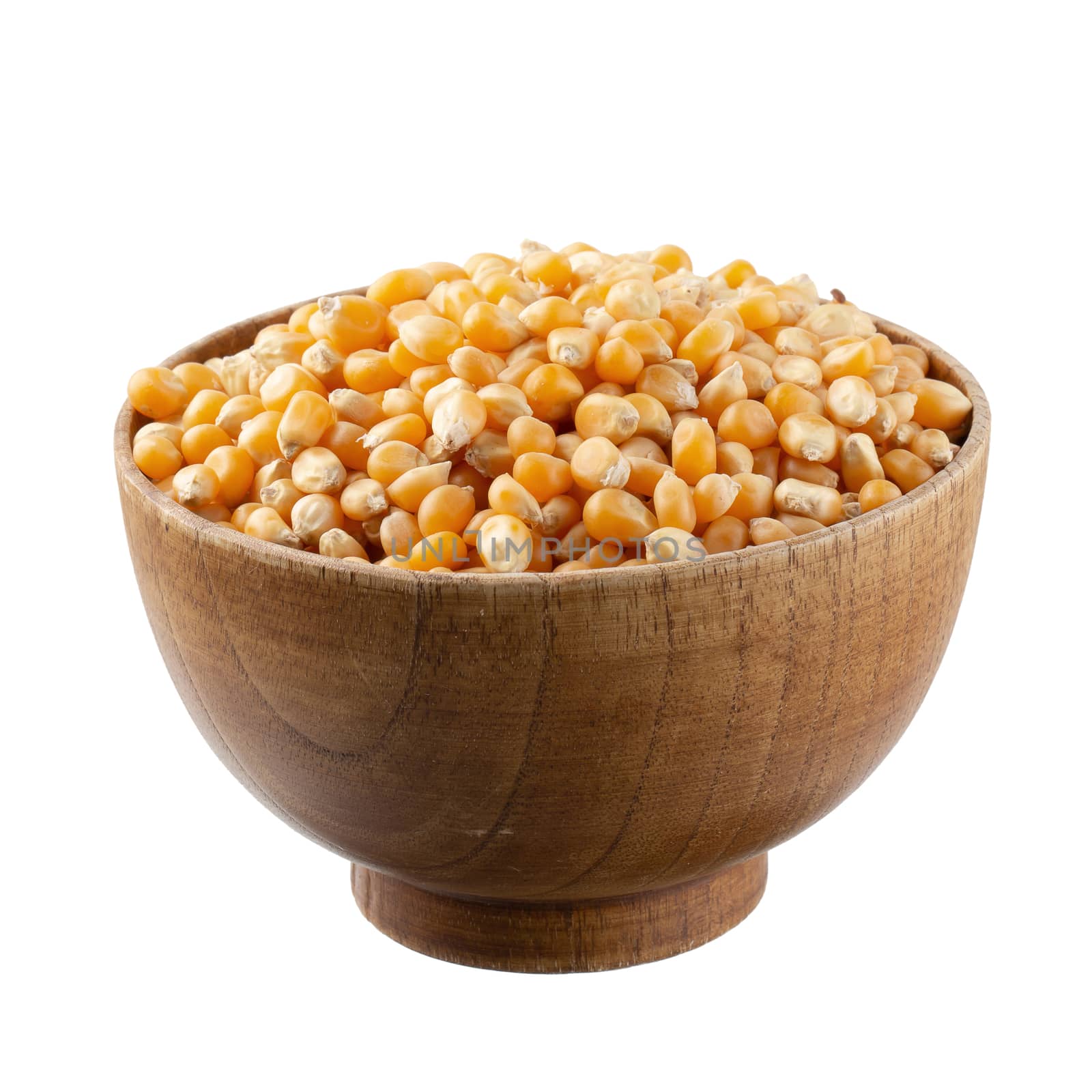 Corn seeds in a wooden bowl isolated on a white background.