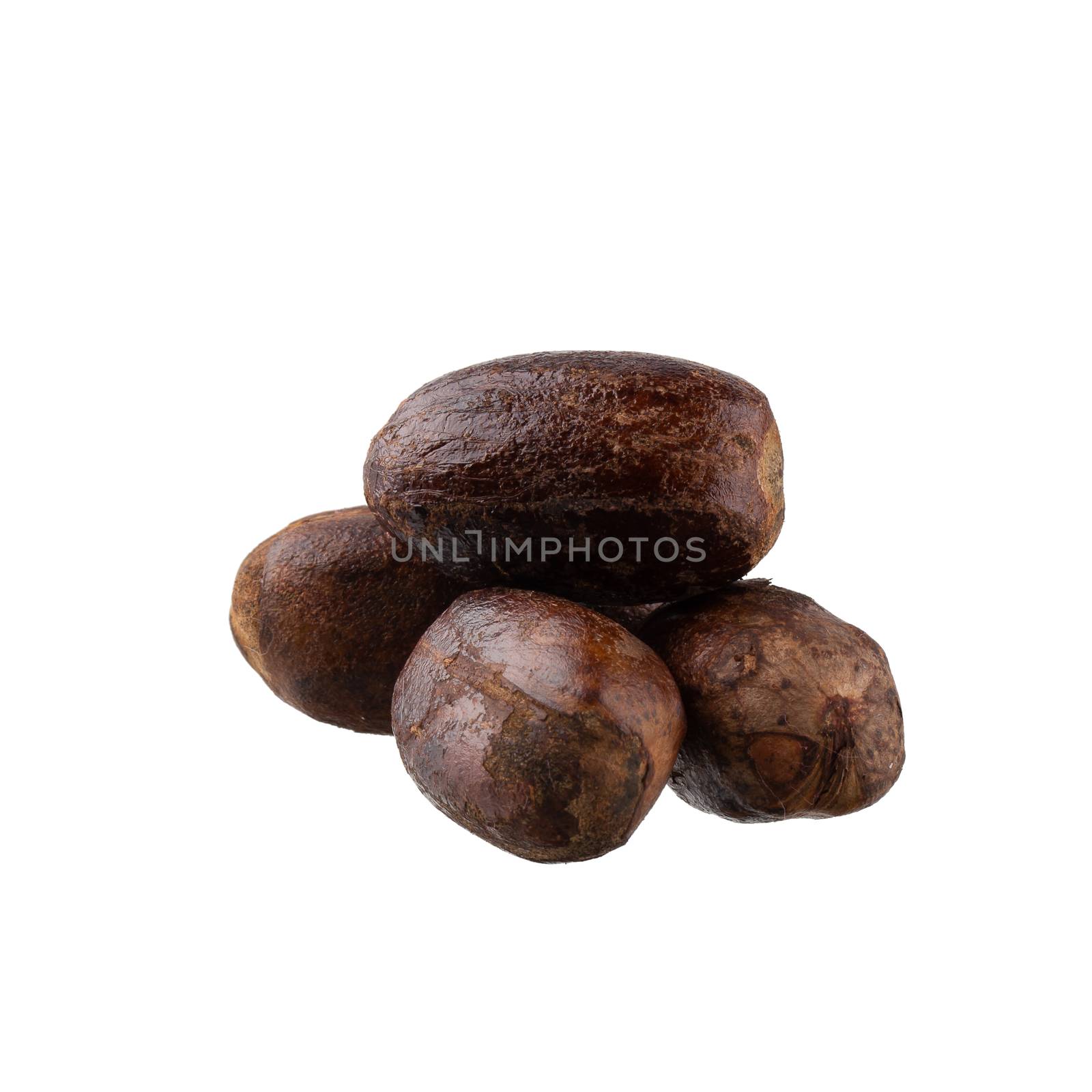 Dry nutmeg spice isolated on a white background.