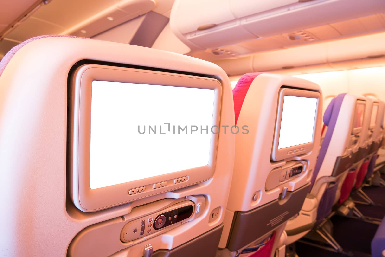 Seat monitor in passenger plane. by Alicephoto