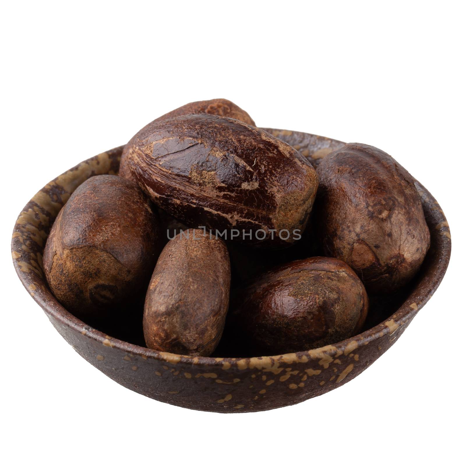 Dry nutmeg spice isolated on a white background by kaiskynet