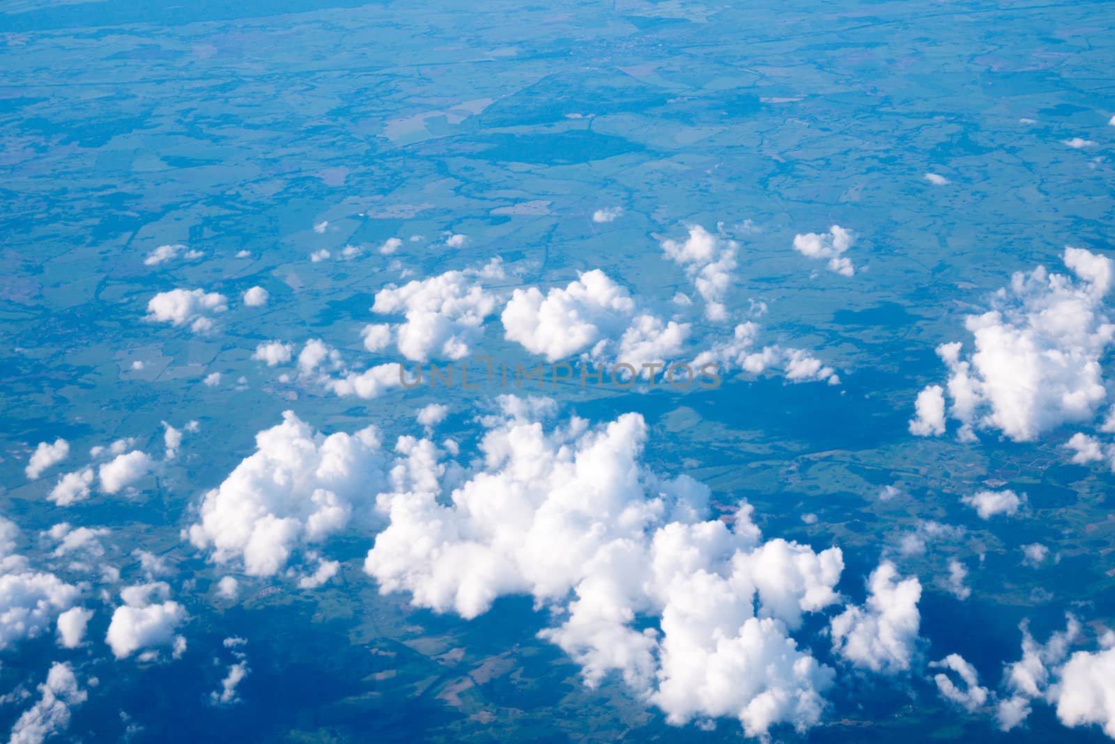 Clouds and sky sunny day through airplane window by Alicephoto