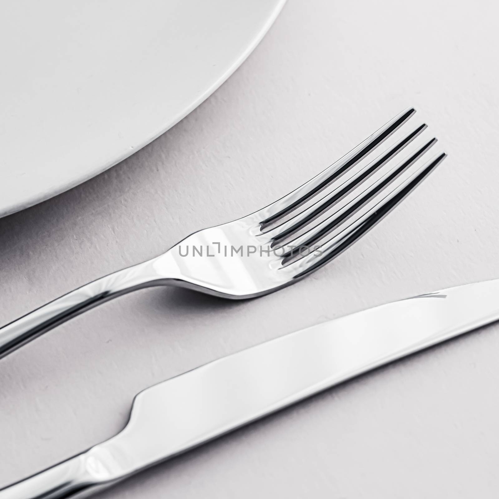 Empty plate and cutlery as mockup set on white background, top tableware for chef table decor and menu branding by Anneleven