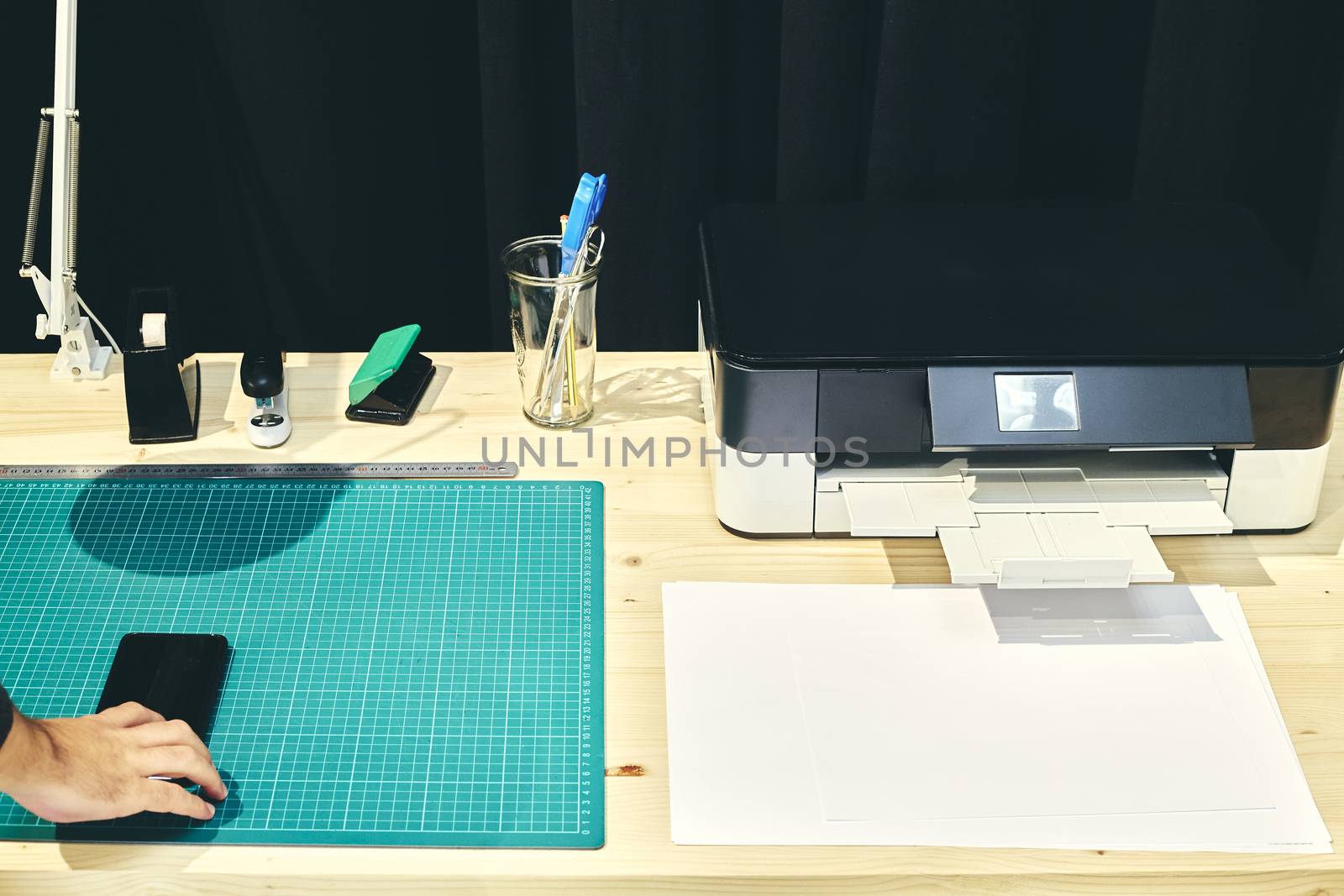 Vision of a desk with its printer and a mobile phone