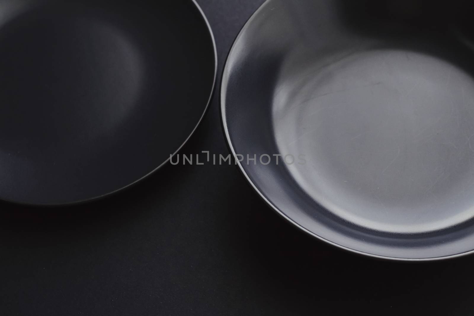 Empty plates on black background, premium dishware for holiday dinner, minimalistic design and diet by Anneleven