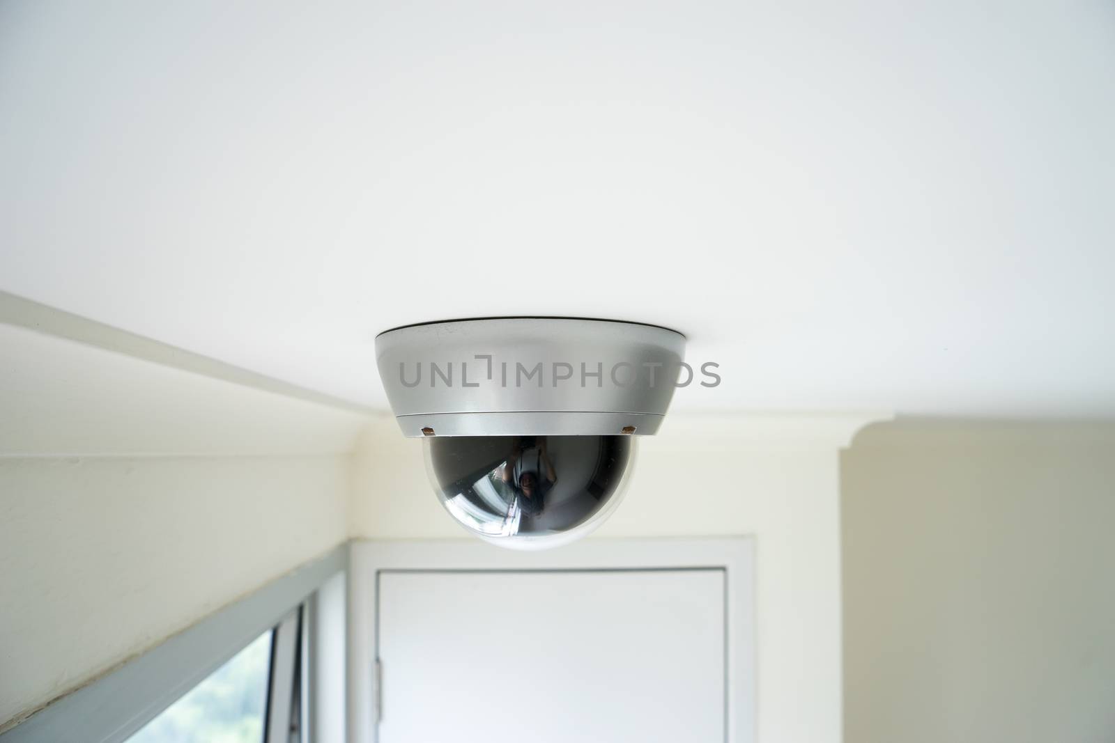 CCTV security camera monitor in office building by Alicephoto