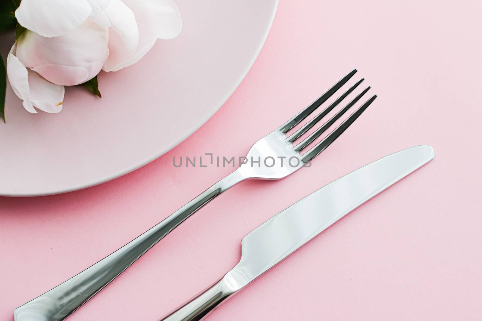 Dining plate and cutlery with peony flowers as wedding decor set on pink background, top tableware for event decoration and menu branding design