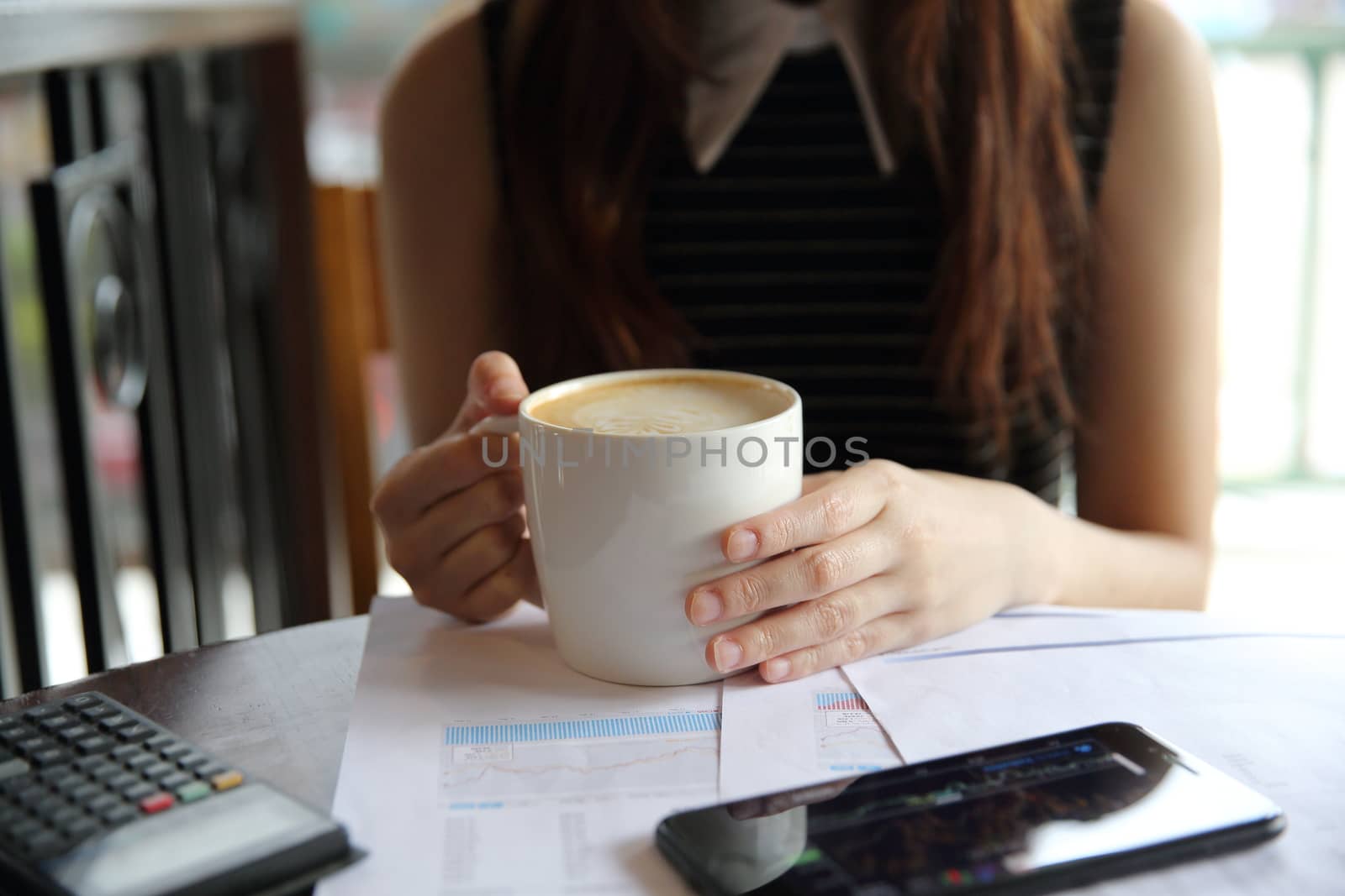 A business woman hand with coffee and business paper by piyato