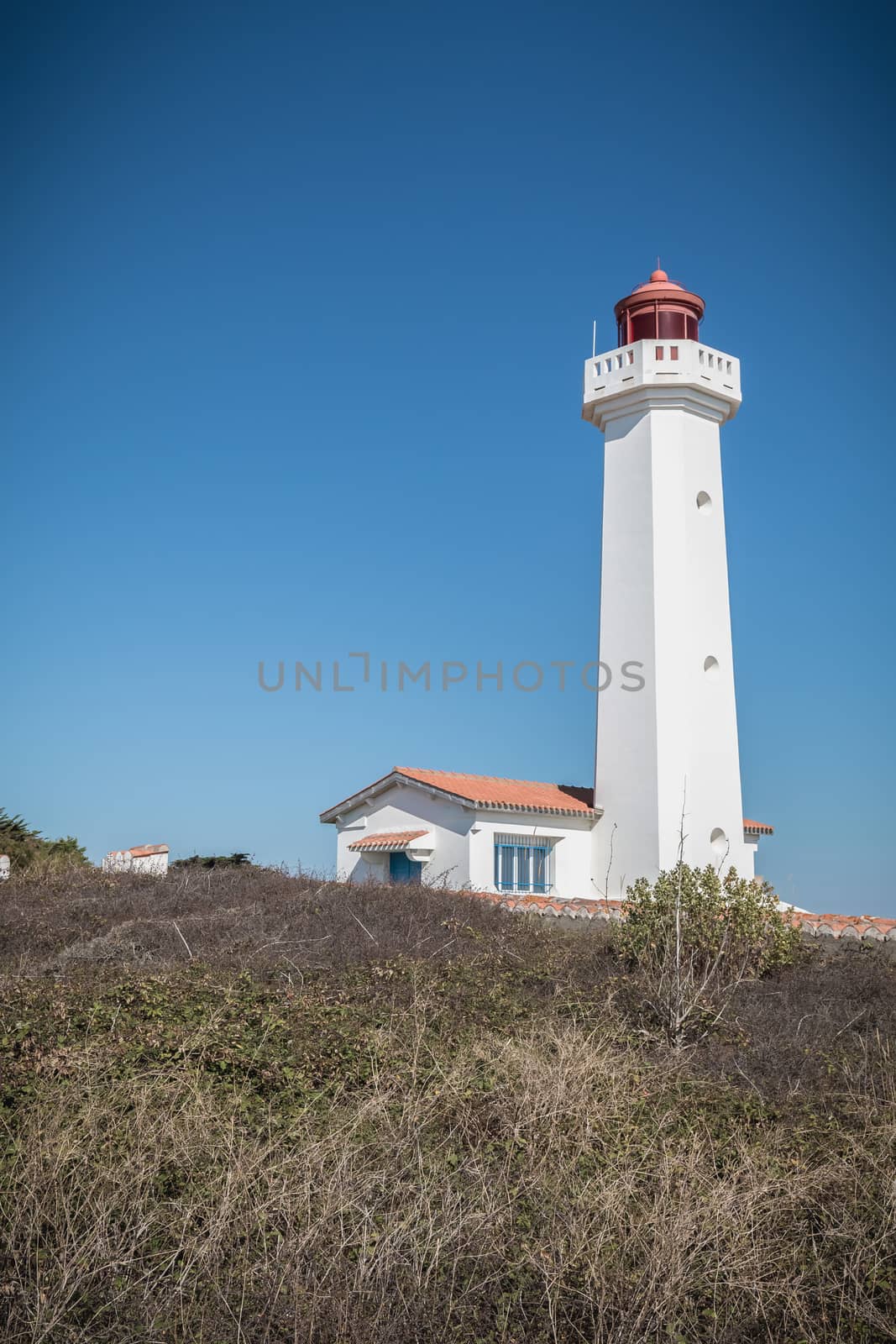 Port Joinville, France - September 17, 2018 - Architectural detail of the Corbeaux Marine Lighthouse on a summer day