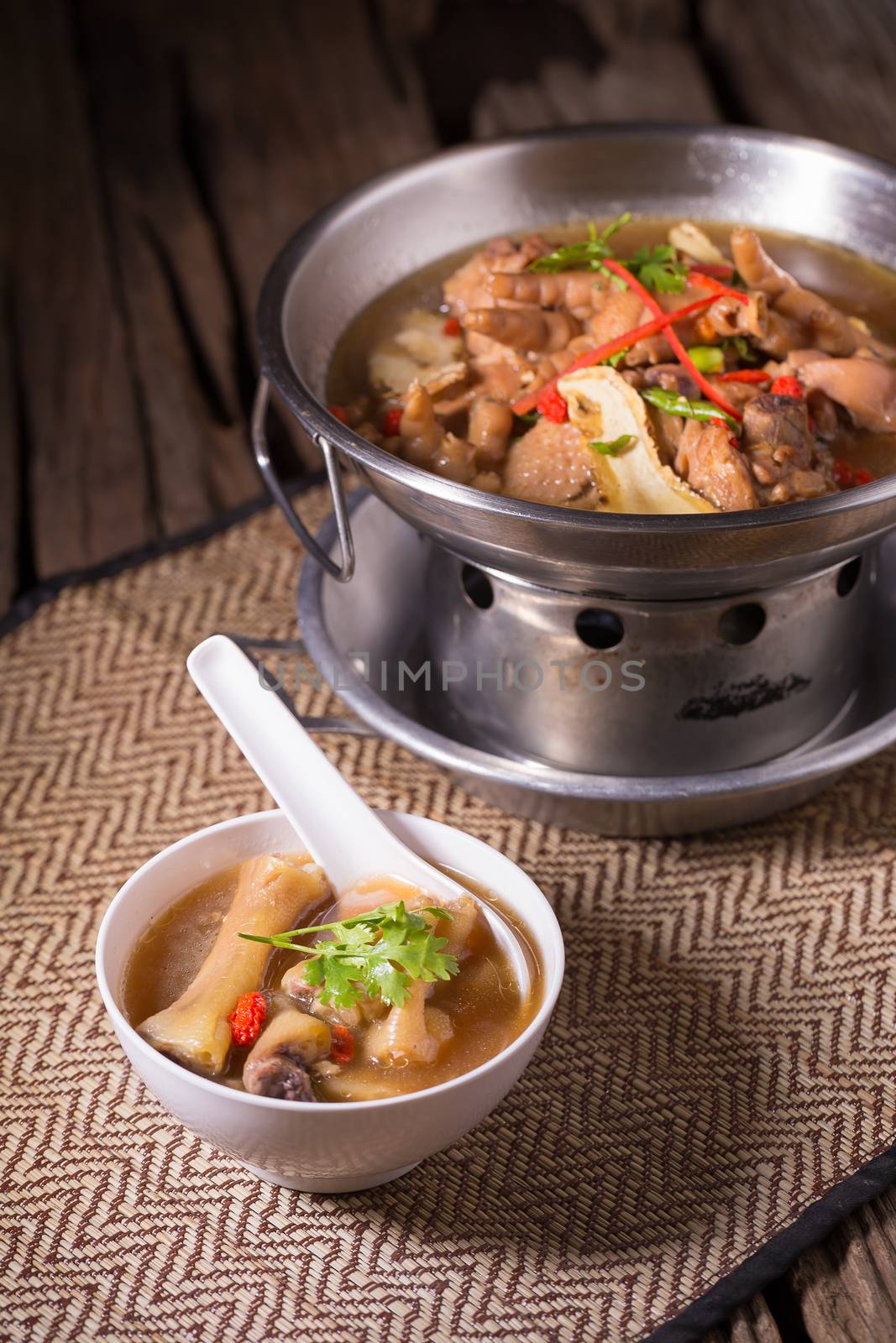 Chicken and herb soup in pot by kaiskynet