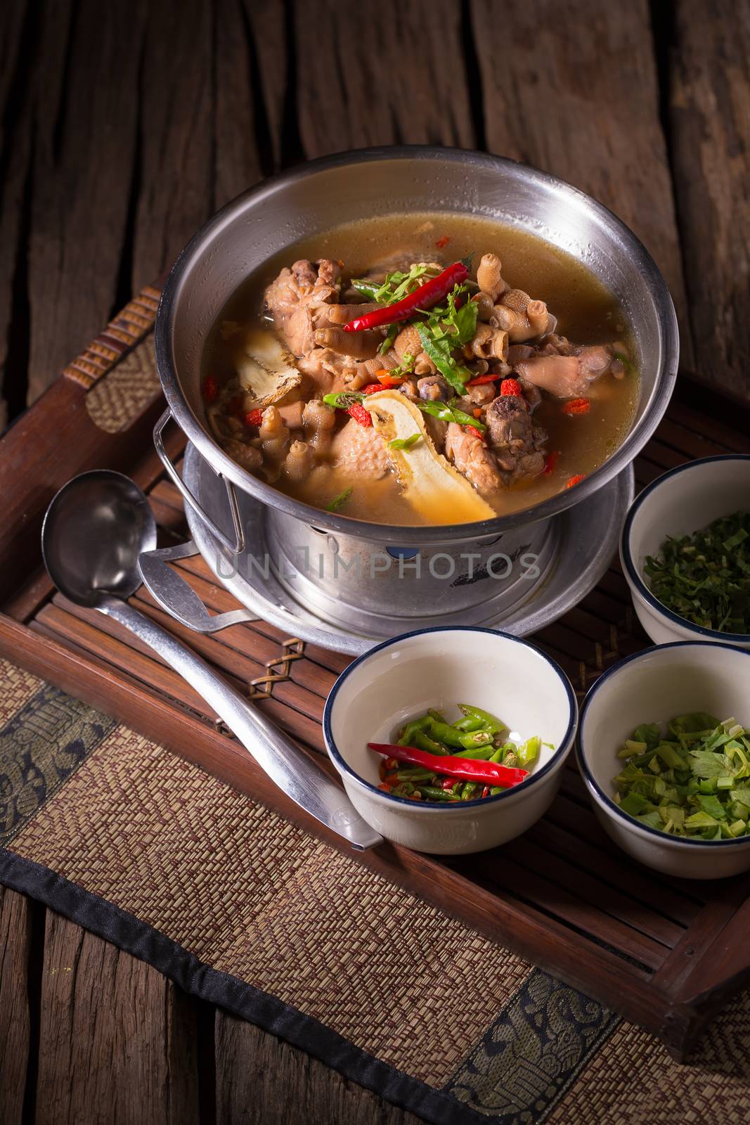 Chicken and herb soup in pot by kaiskynet