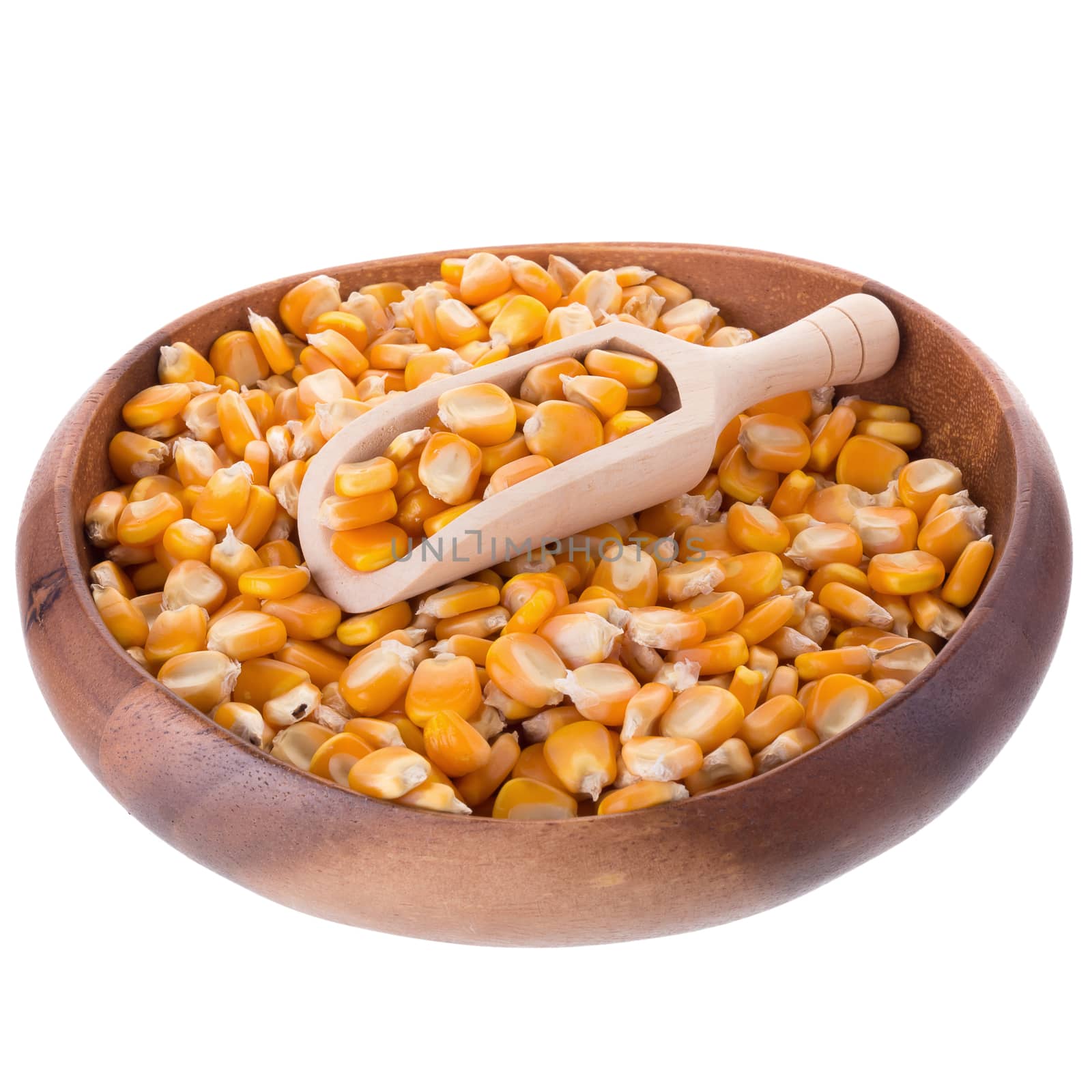 Corn seeds and wooden spoon isolated on a white background.