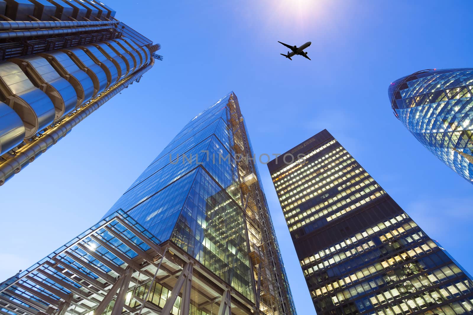 A jet airplane silhouette with business office towers background