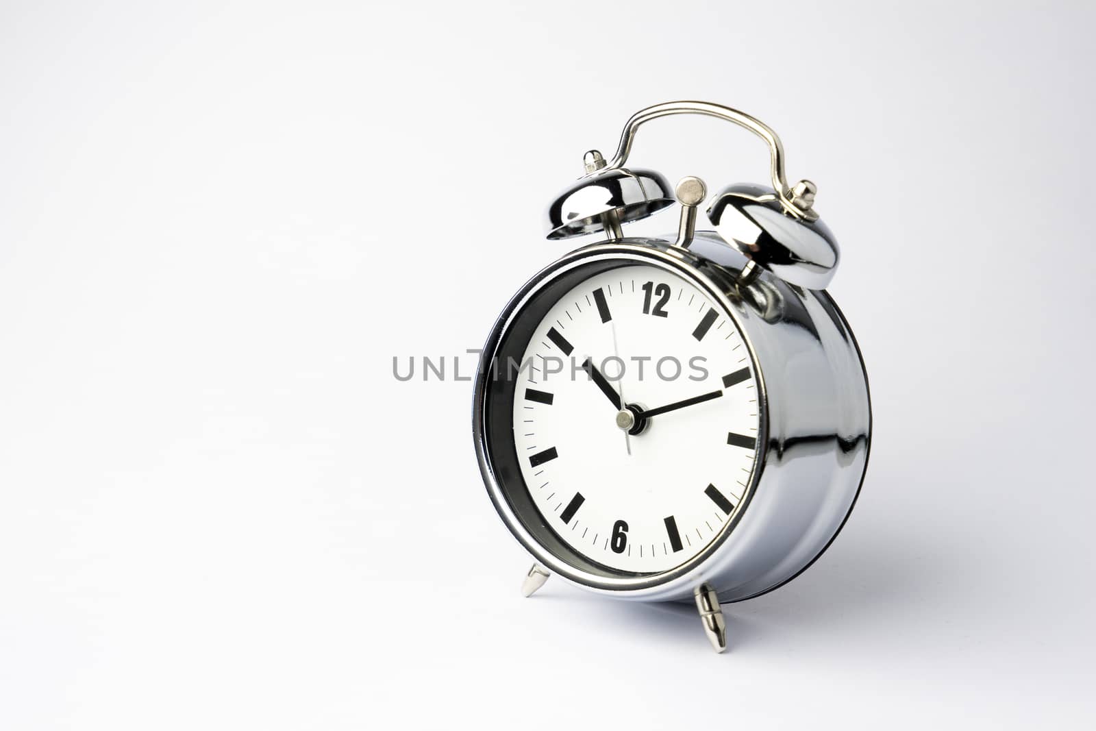 Alarm metal clock on white background by Alicephoto