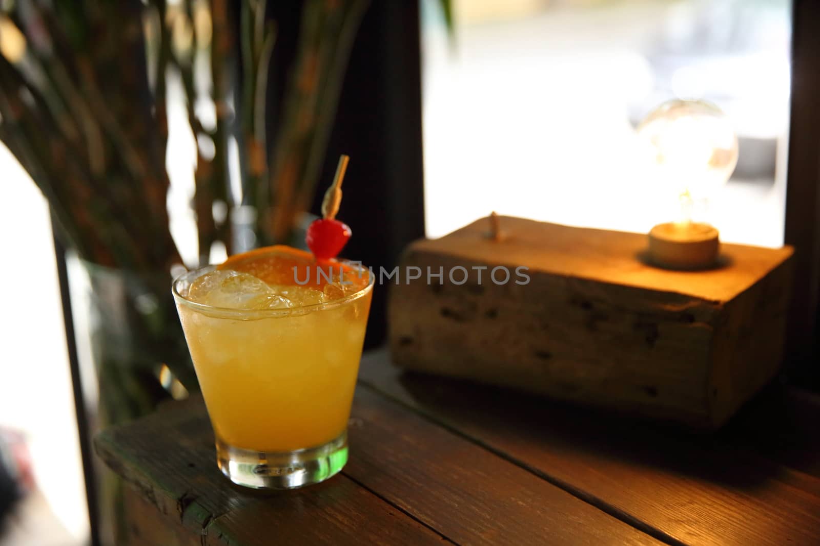 mai tai cocktail with orange cherry fruits on wood background