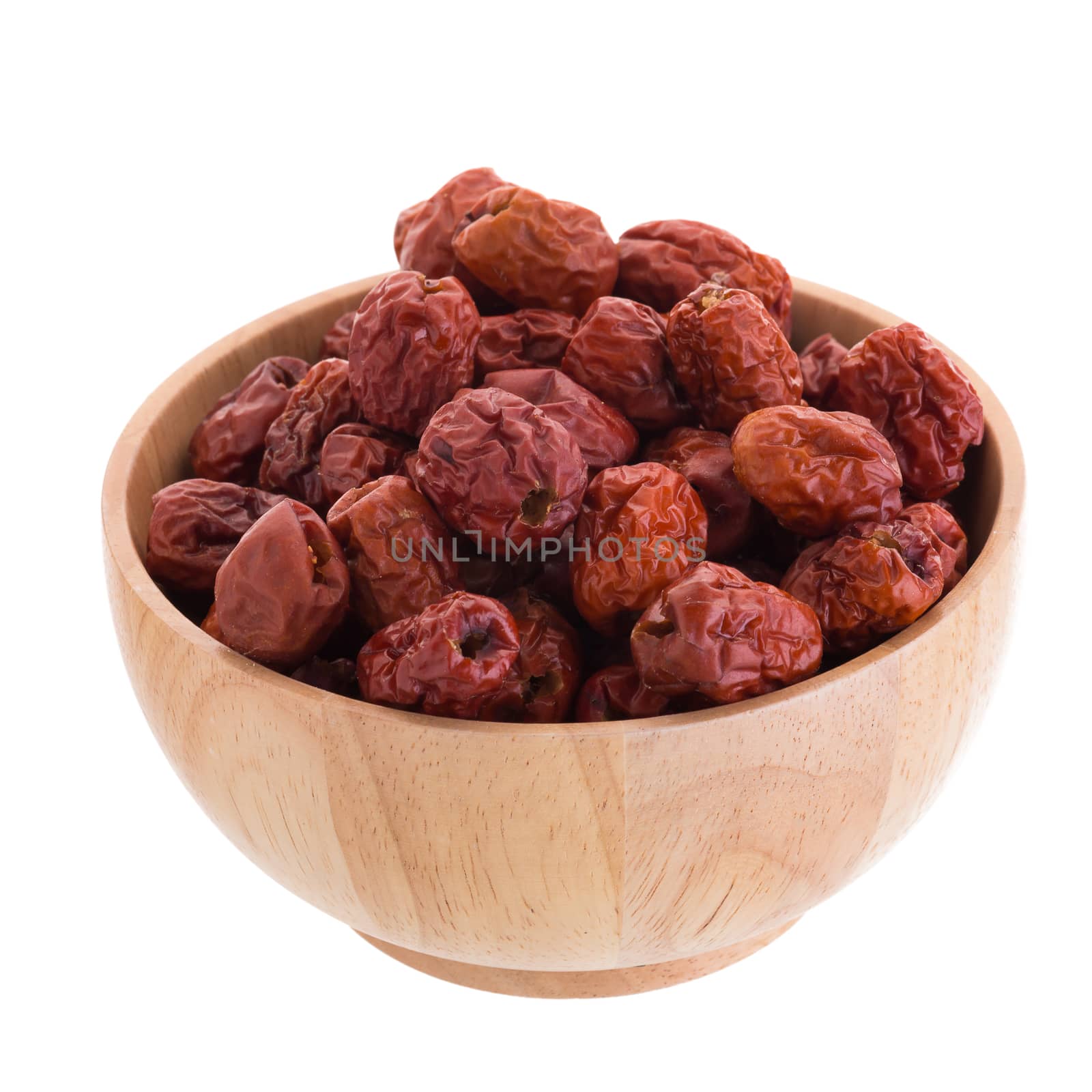 Dried jujube fruits in wooden bowl chinese herbal medicine on a white background.