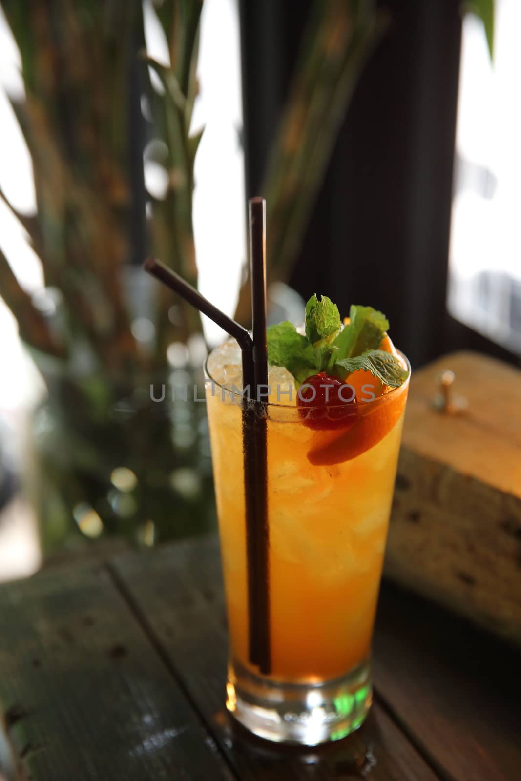 mai tai cocktail with orange cherry fruits on wood background