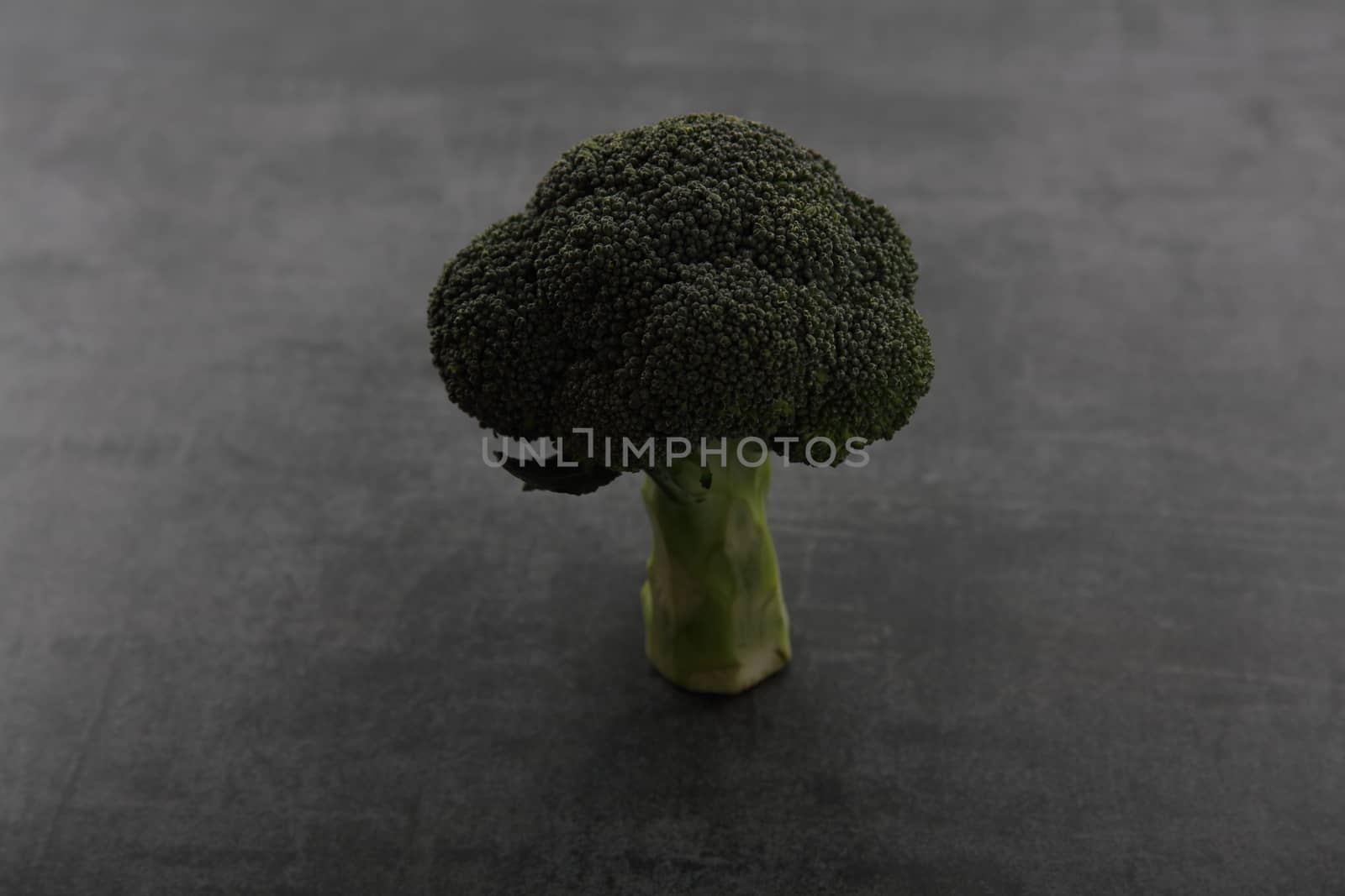 Vegetable broccoli isolated on dark rock background