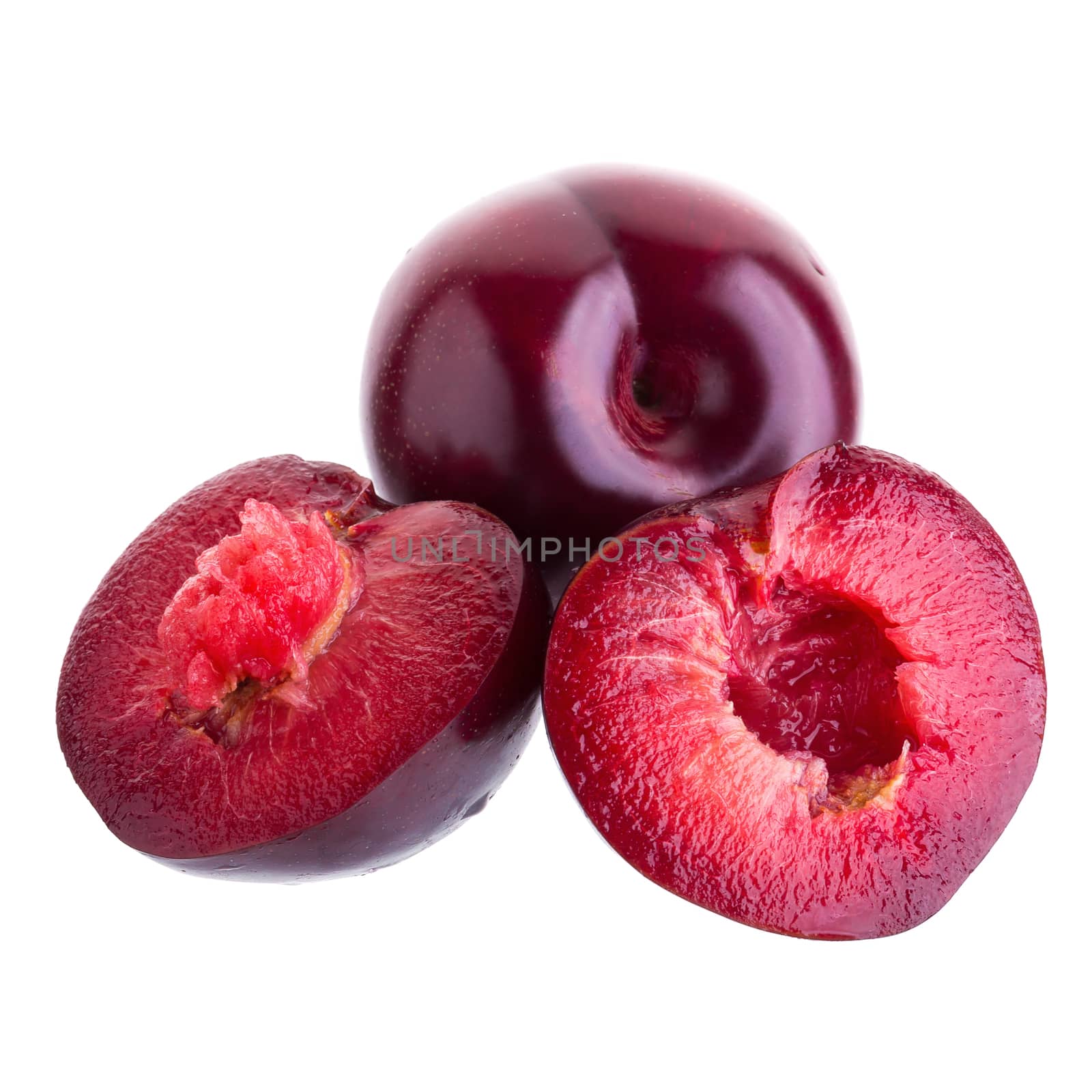 ripe fresh plum with half and slice isolated on white background.