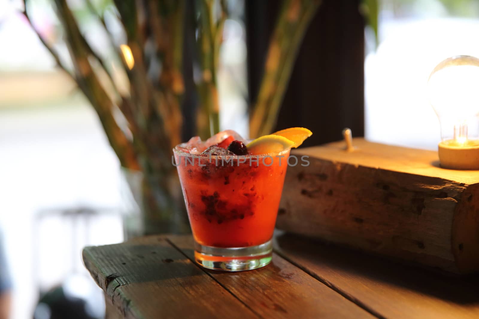 mai tai cocktail with orange cherry fruits on wood background