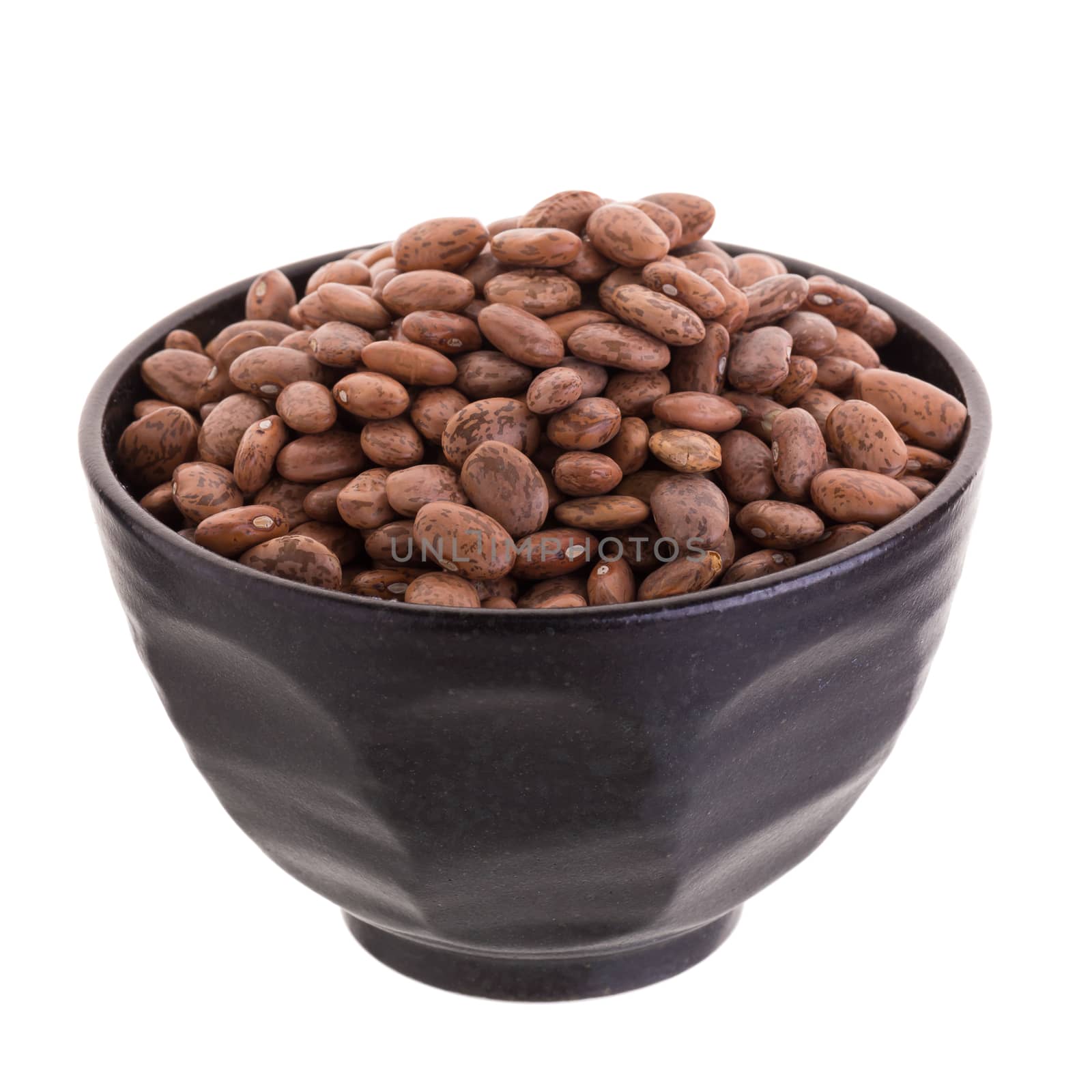 pinto beans  in a ceramic bowl isolated on a white background