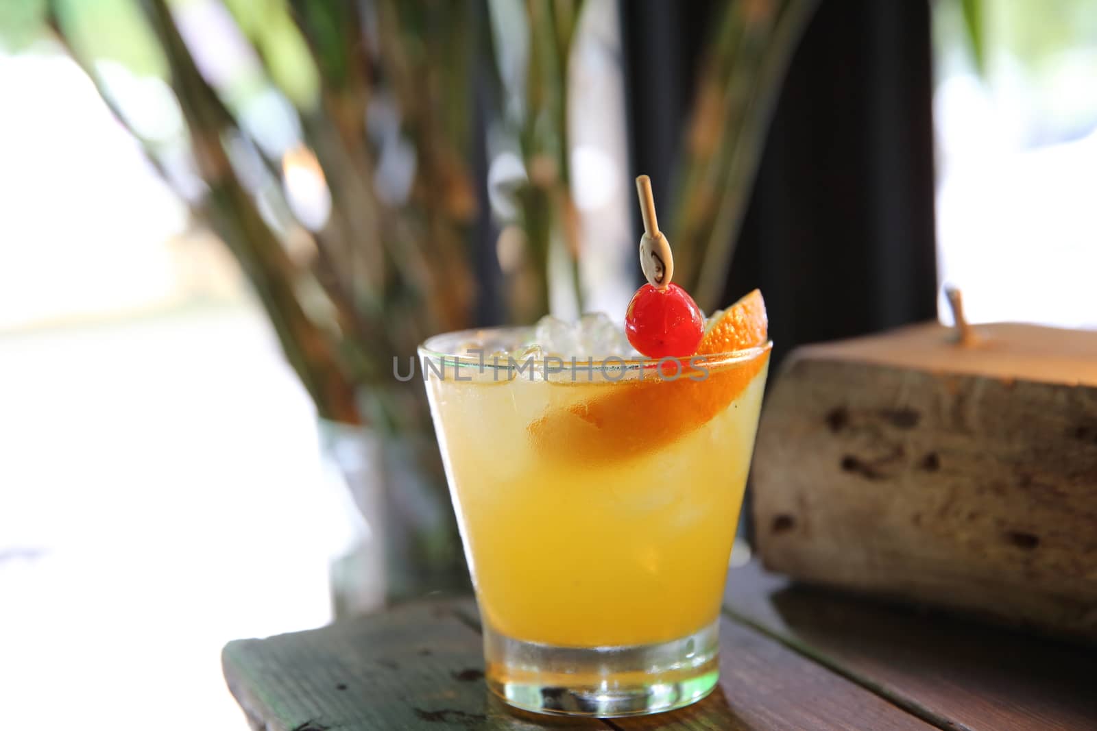 mai tai cocktail with orange cherry fruits on wood background
