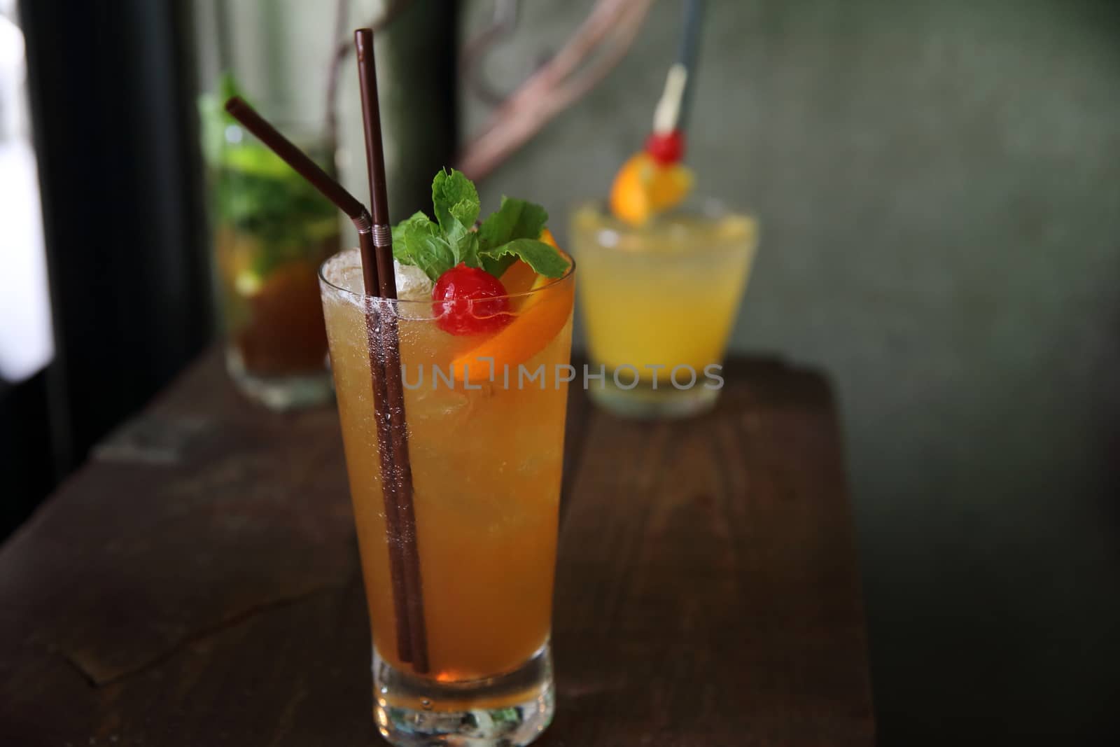 mai tai cocktail with orange cherry fruits on wood background