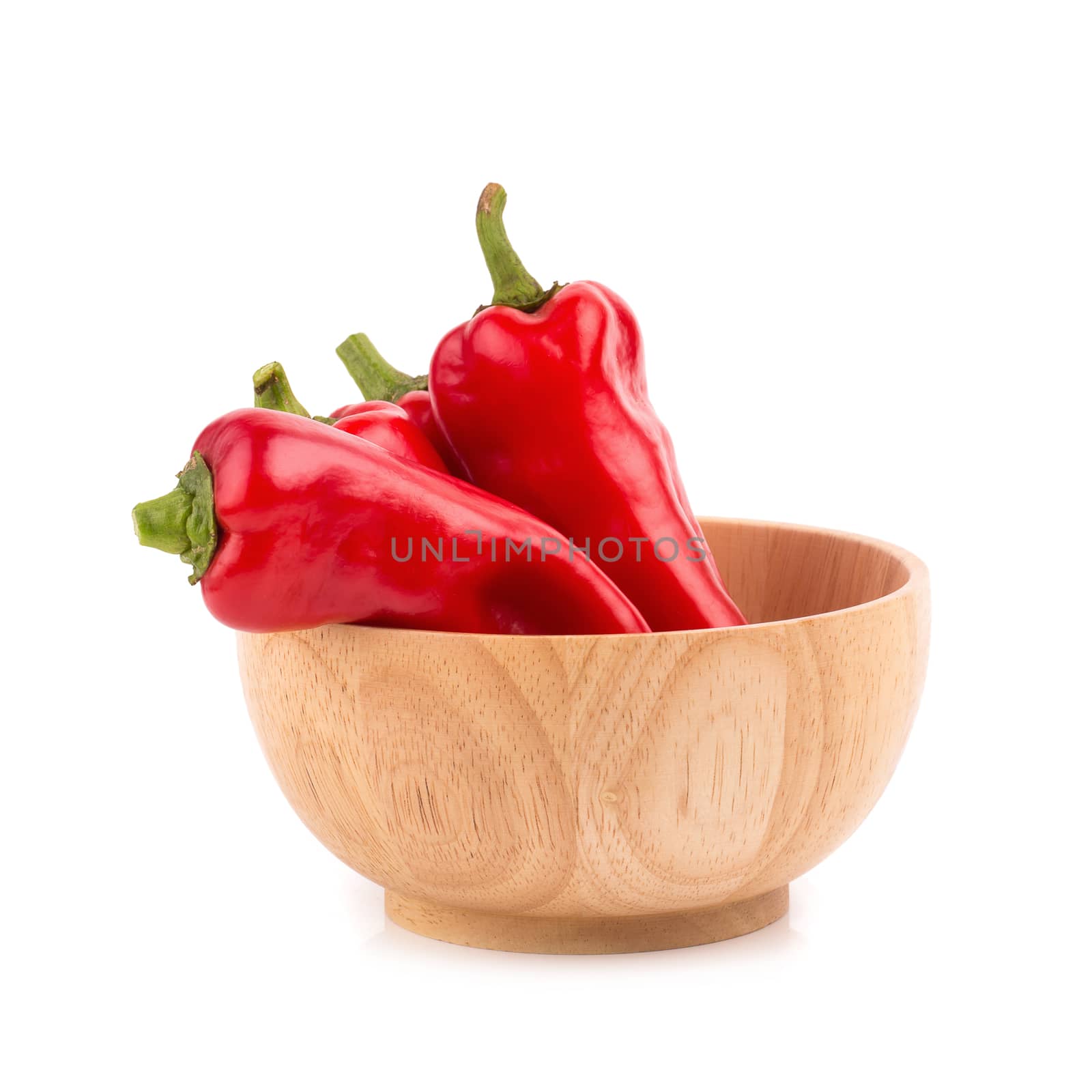 red chilli vegetable in Wooden bowl Isolated on white background by kaiskynet