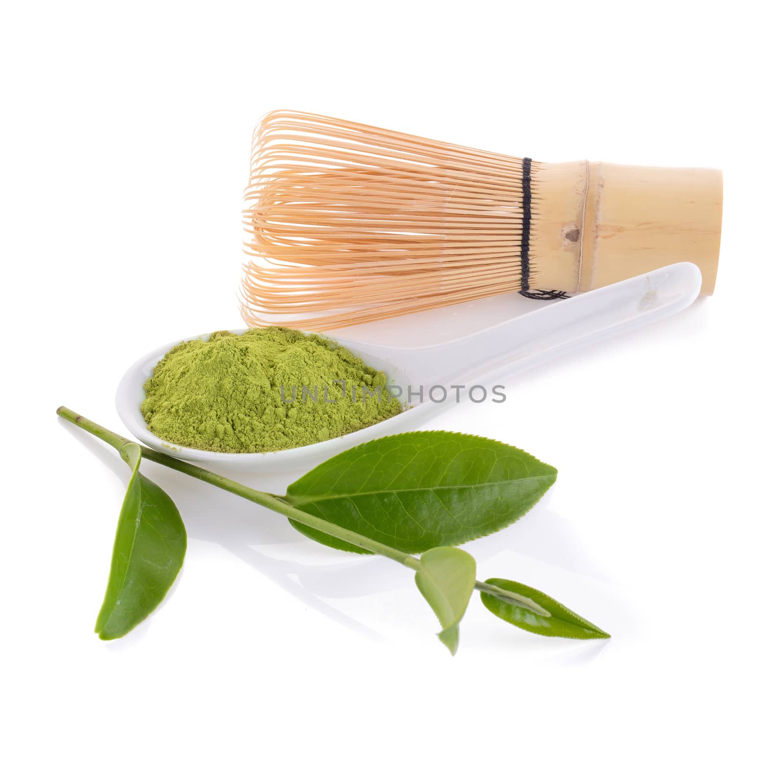 matcha powder in White ceramic spoon and whisk isolated on white background.
