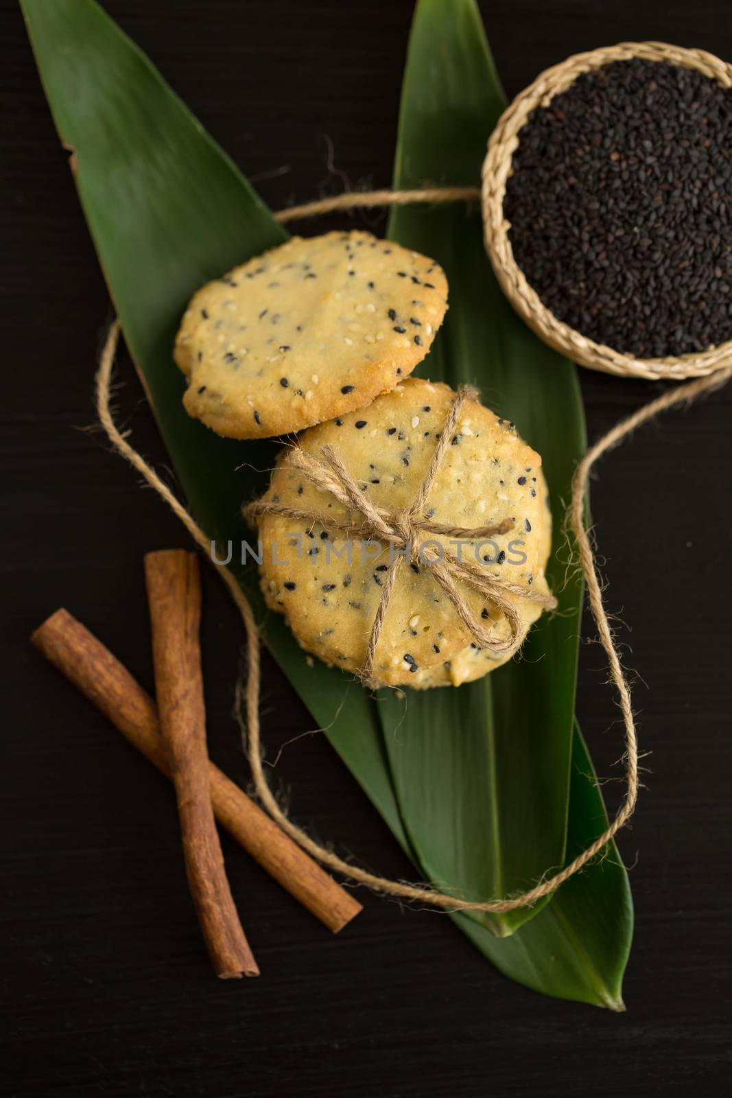 Sesame Cookies, sesame and milk on black wooden background by kaiskynet