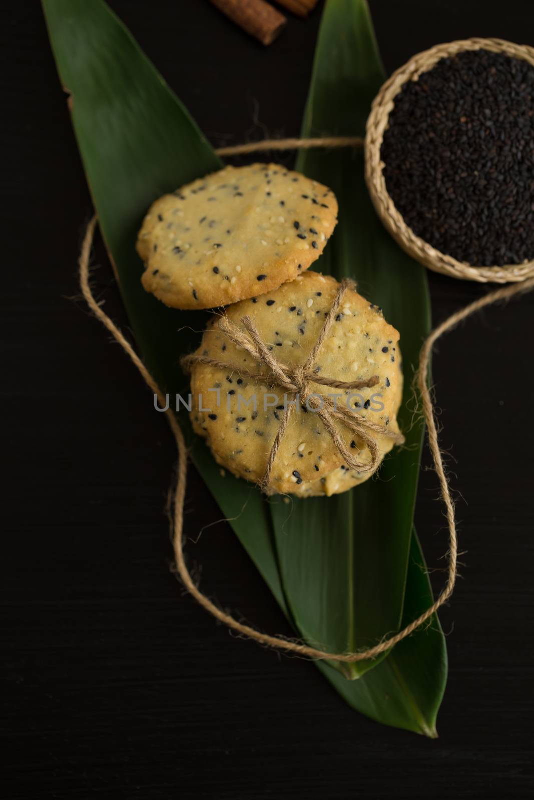 Sesame Cookies, sesame and milk on black wooden background by kaiskynet