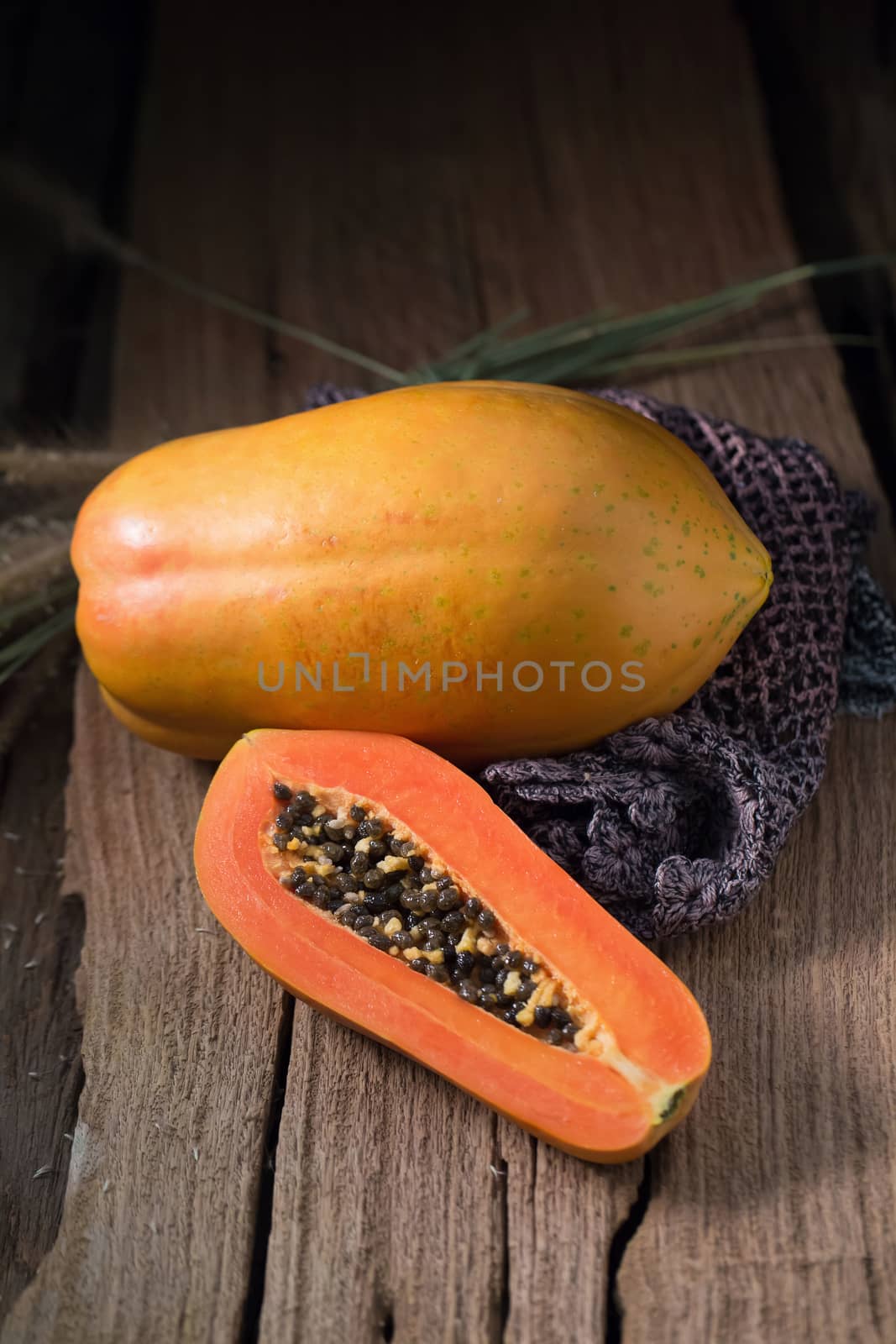 Papaya on wooden background. Sliced of papaya. by kaiskynet