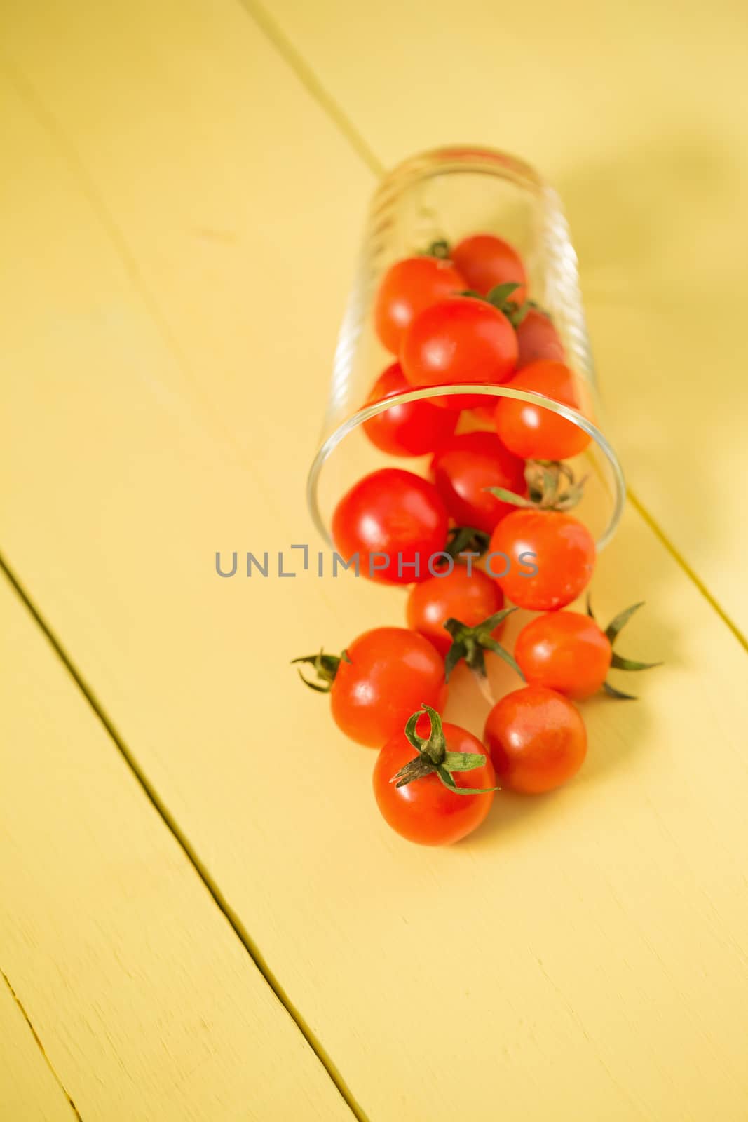 Fresh tomatoes Healthy food concept. on yellow table background.