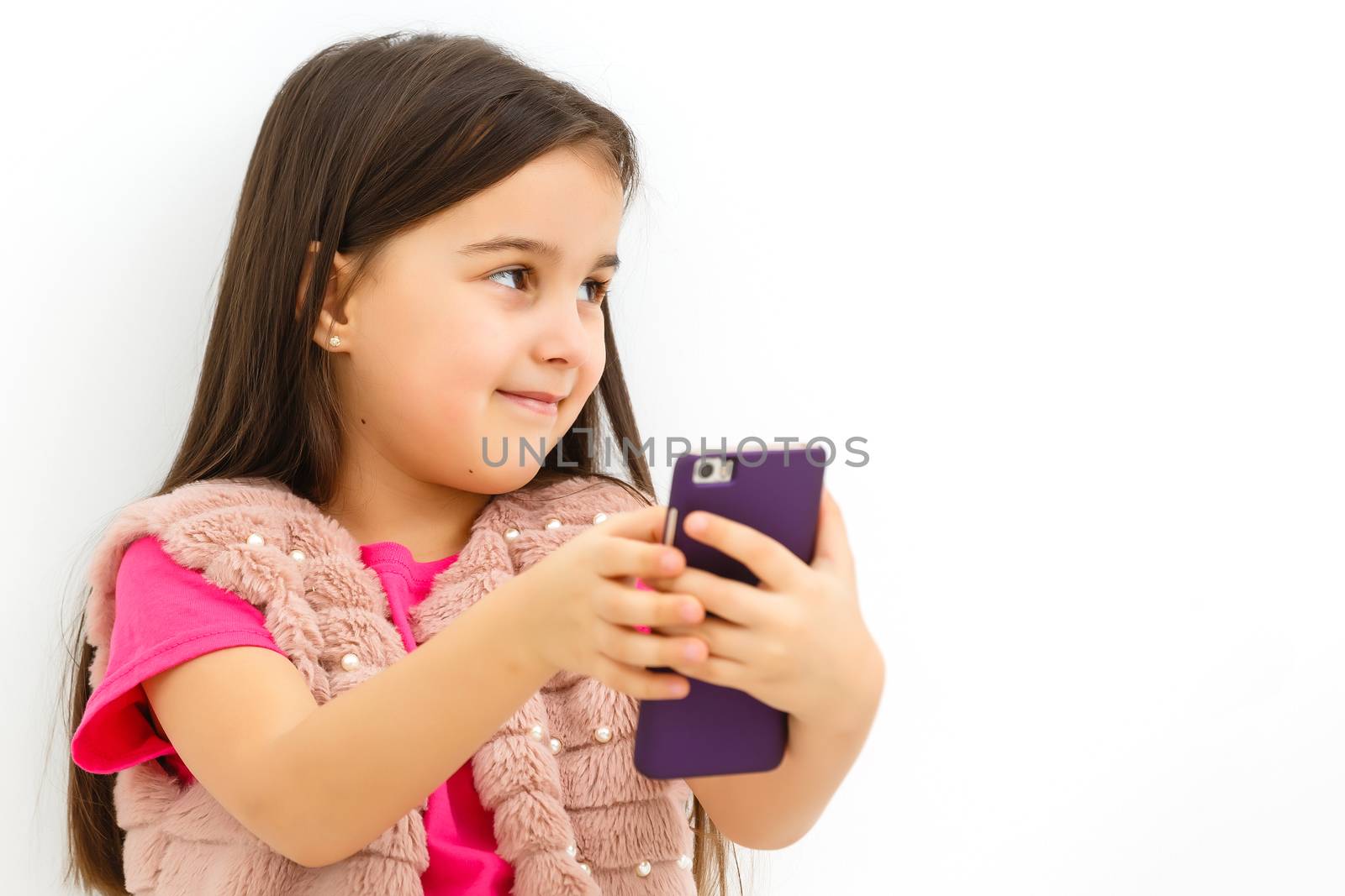Little girl holding a smart phone against white background