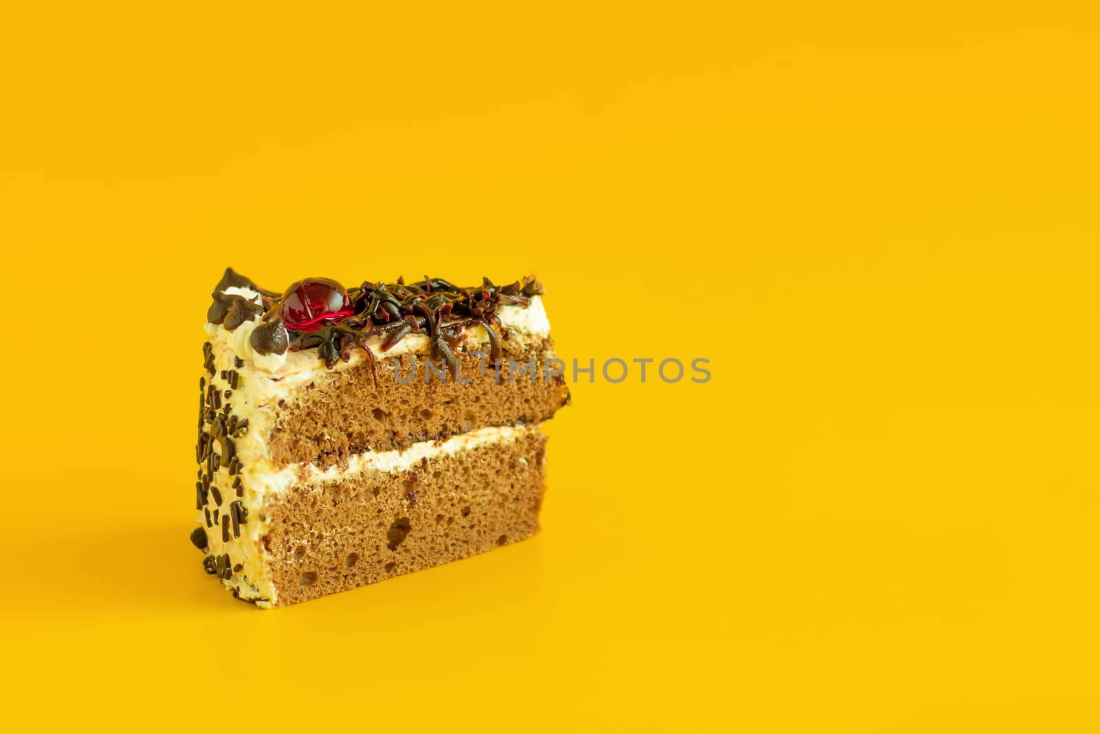 Chocolate cake on a yellow background. copy space.