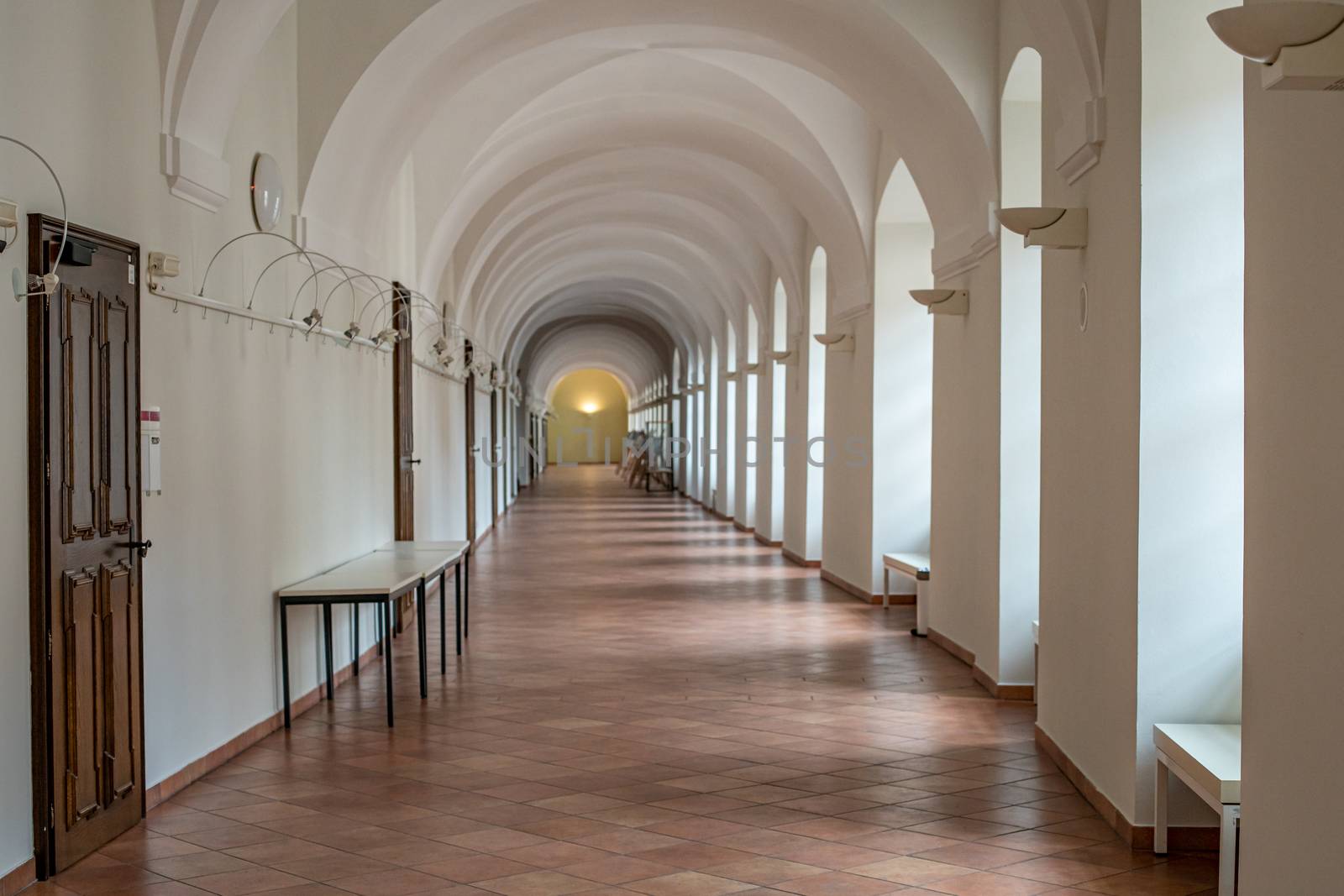 white hallway with many doors and lights in public buildings University by Edophoto