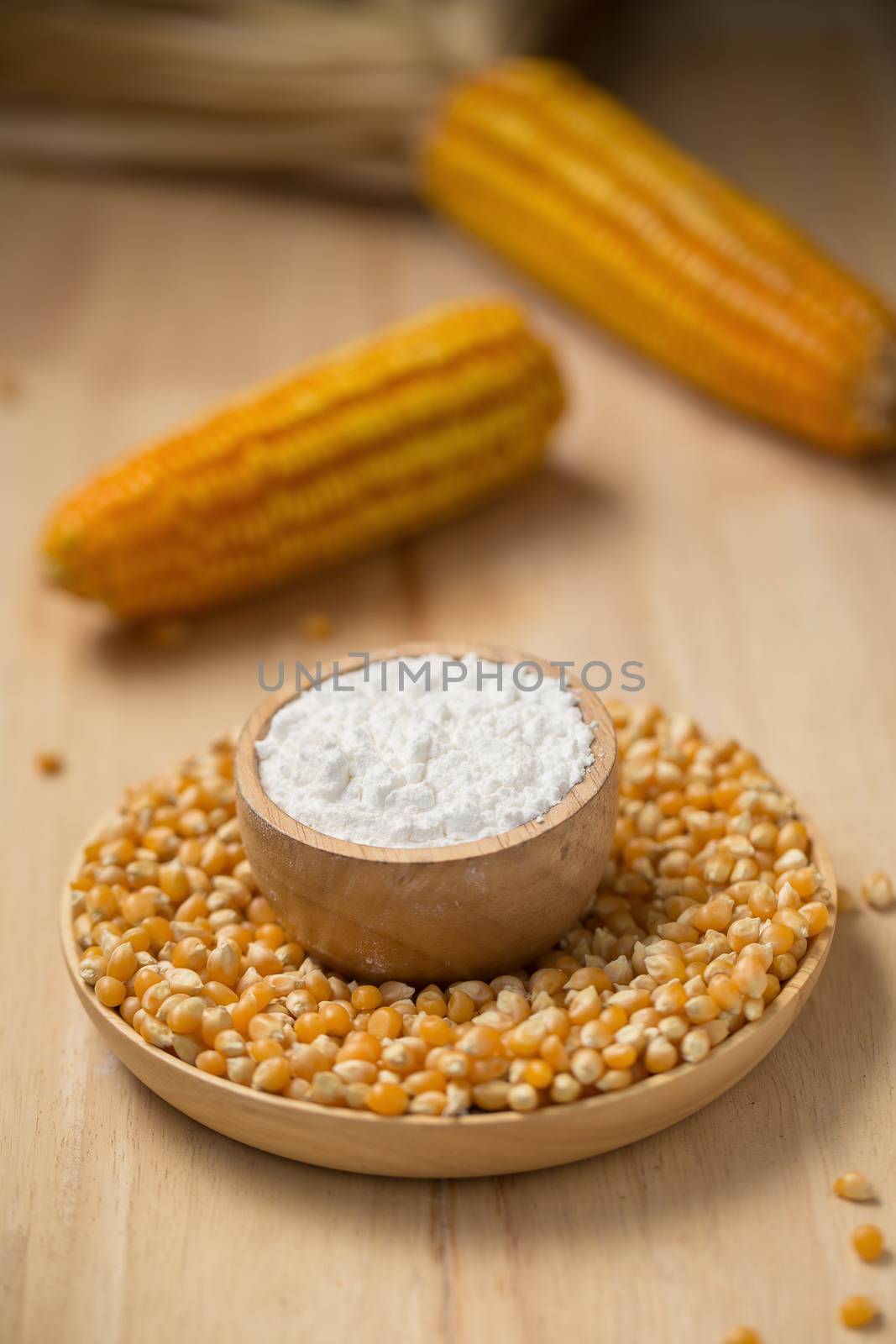 Corn flour in a bowl over a wooden table by kaiskynet