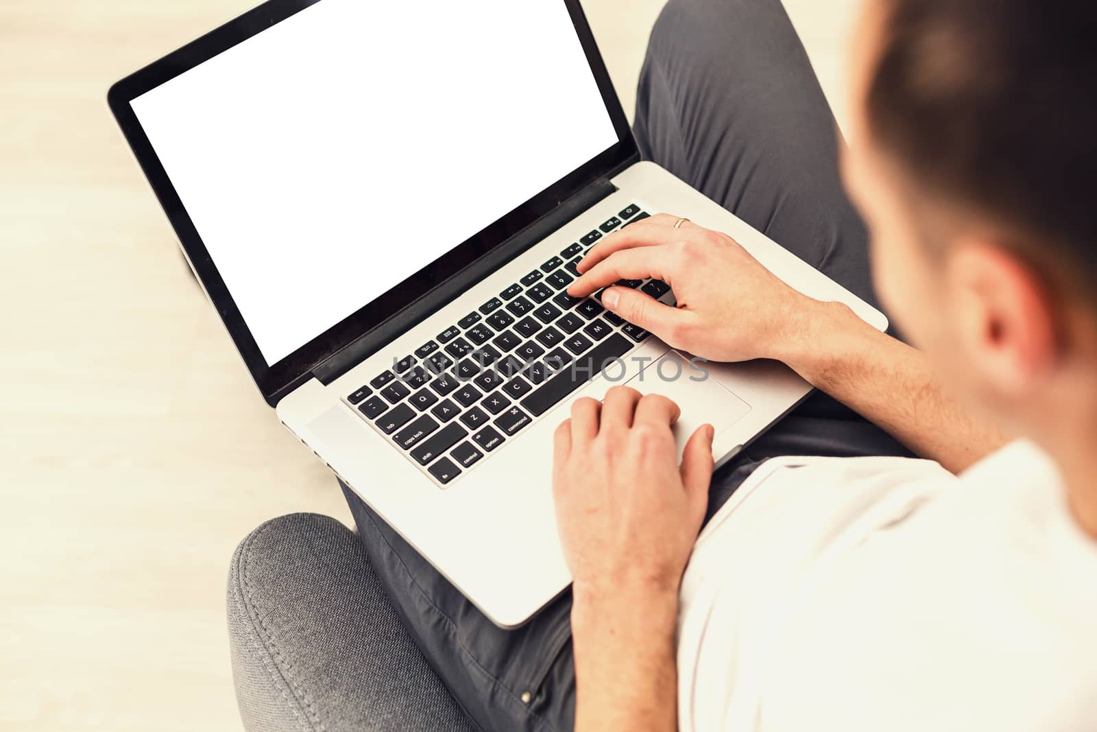 Cropped image of a young man working on his laptop, rear view of business man hands busy using laptop, young male student typing on computer sitting by Andelov13