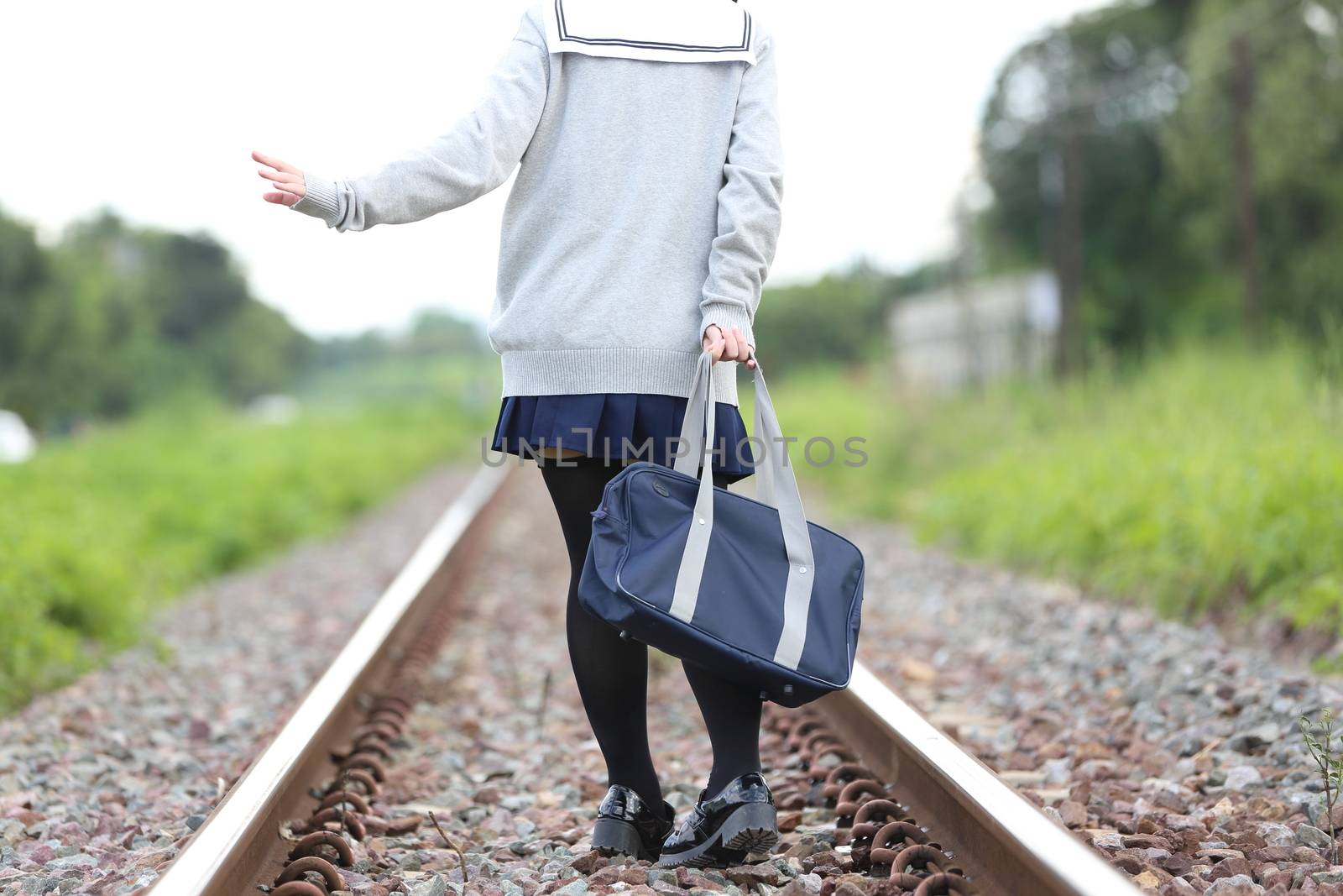 Portrait of Japanese school girl with countryside park
