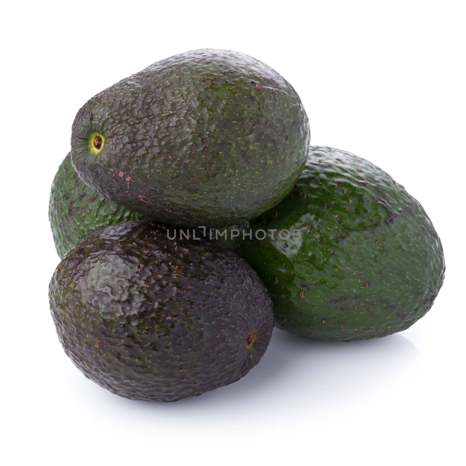 Green ripe avocado isolated on the white background.