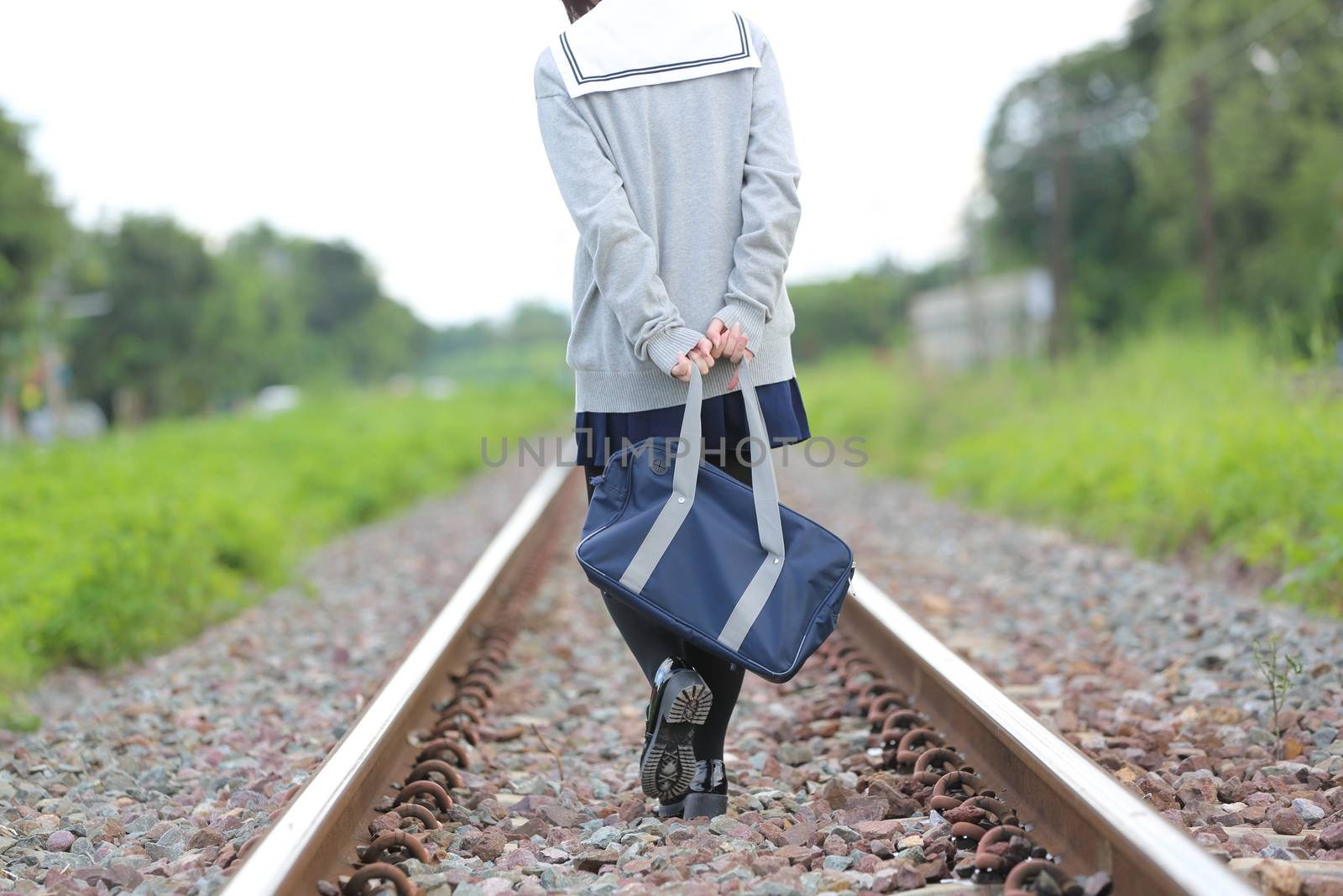 Portrait of Japanese school girl with countryside park