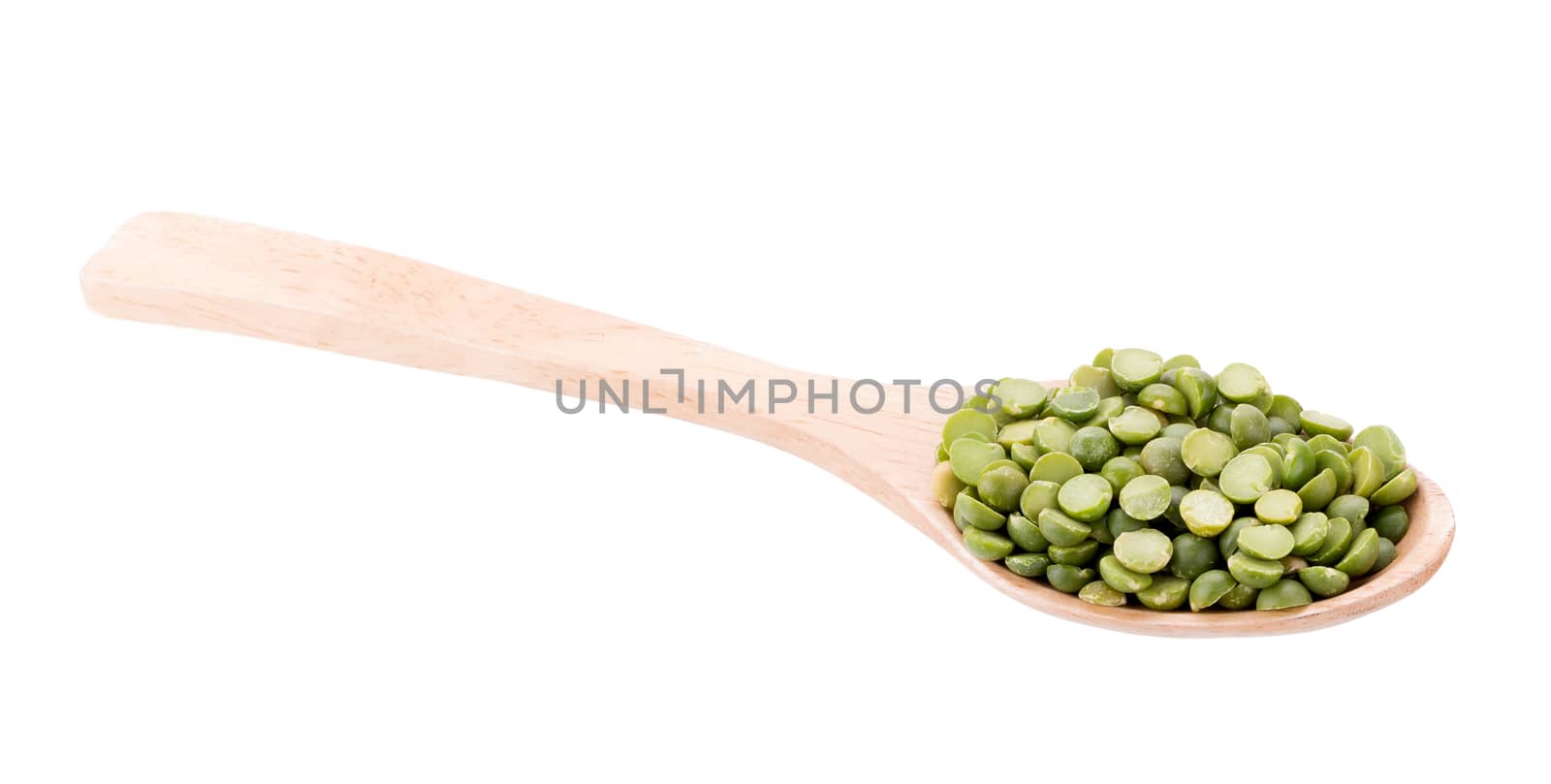 Split Green Peas on wooden spoon isolated on white background.