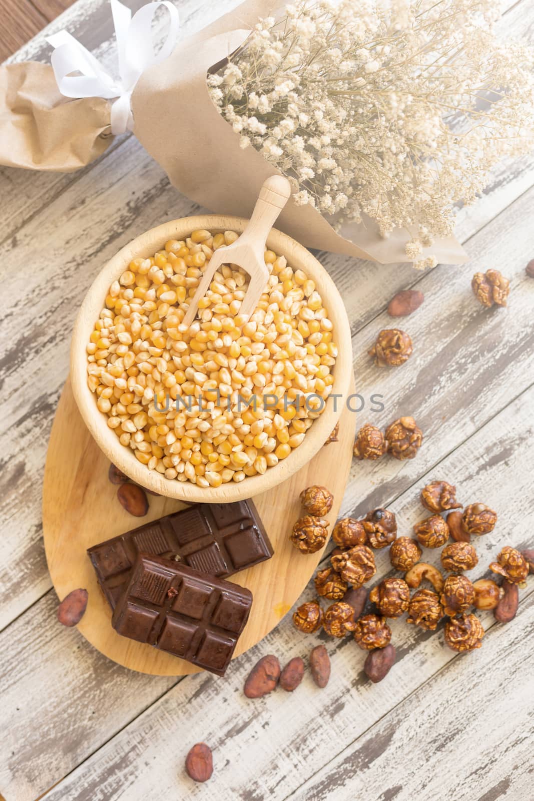Corn kernels in wooden plates and popcorn with Caramel and choco by kaiskynet