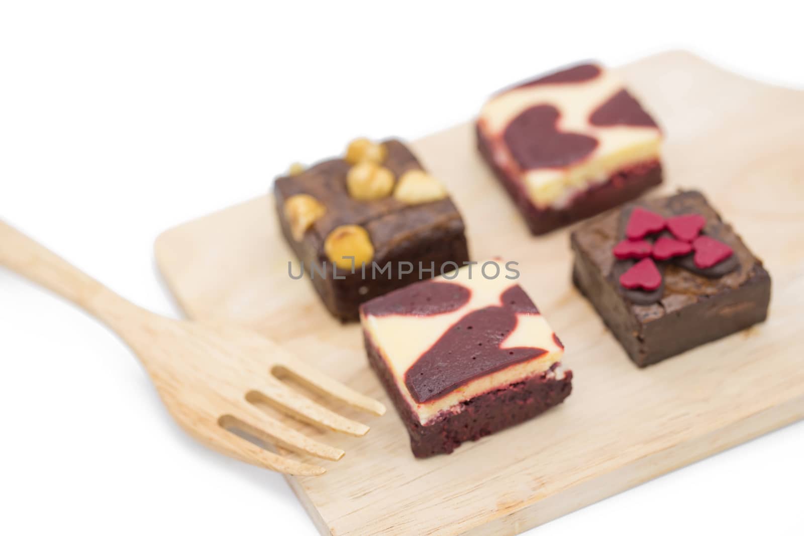 mini brownie on wooden board isolated on white background.