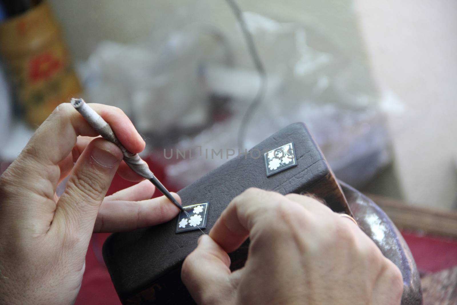 Jeweler mints silver decoration in workshop of Toledo