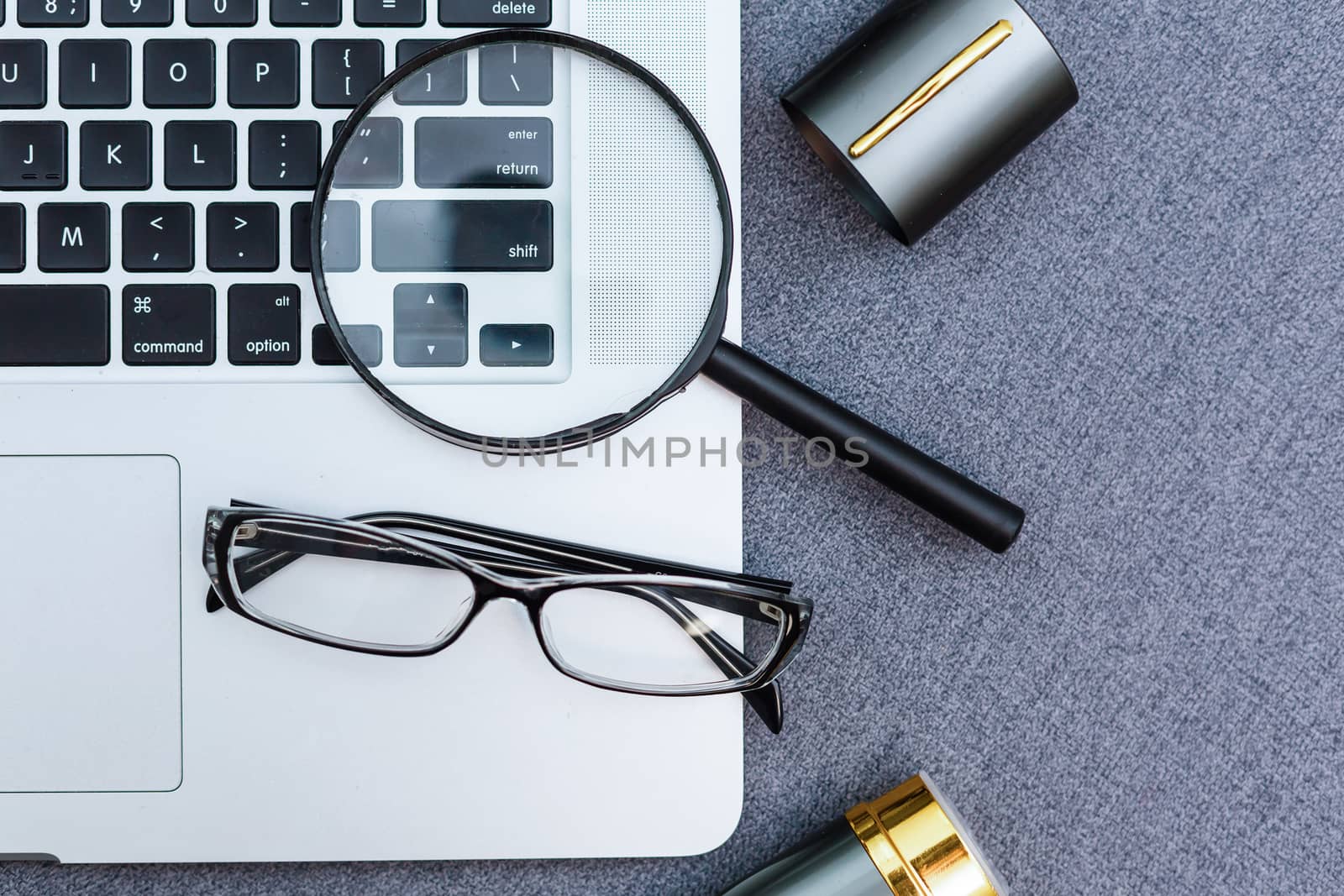 Business summary reports and a magnifying glass with glasses on table office. Concept of Data Analysis, Investment Planning, Business Analytics.